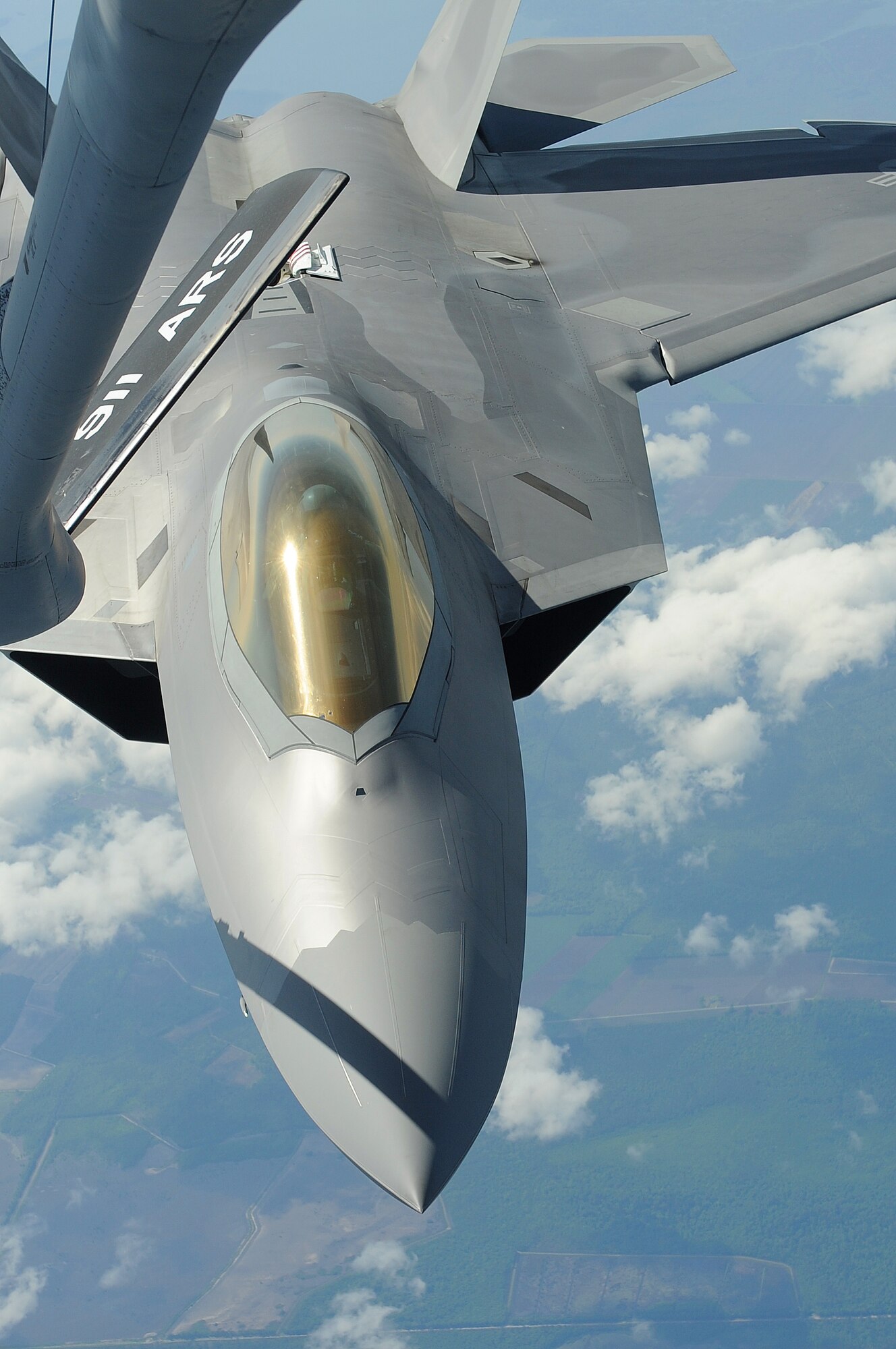 SEYMOUR JOHNSON AIR FORCE BASE, N.C. -- An F-22A Raptor refuels mid-air from a KC-135 Stratotanker during a large force exercise over North Carolina May 2, 2011. The exercise consisted of a strike mission with offensive counter air and suppression-of-enemy-air defense support. (U.S. Air Force photo/Senior Airman Gino Reyes)