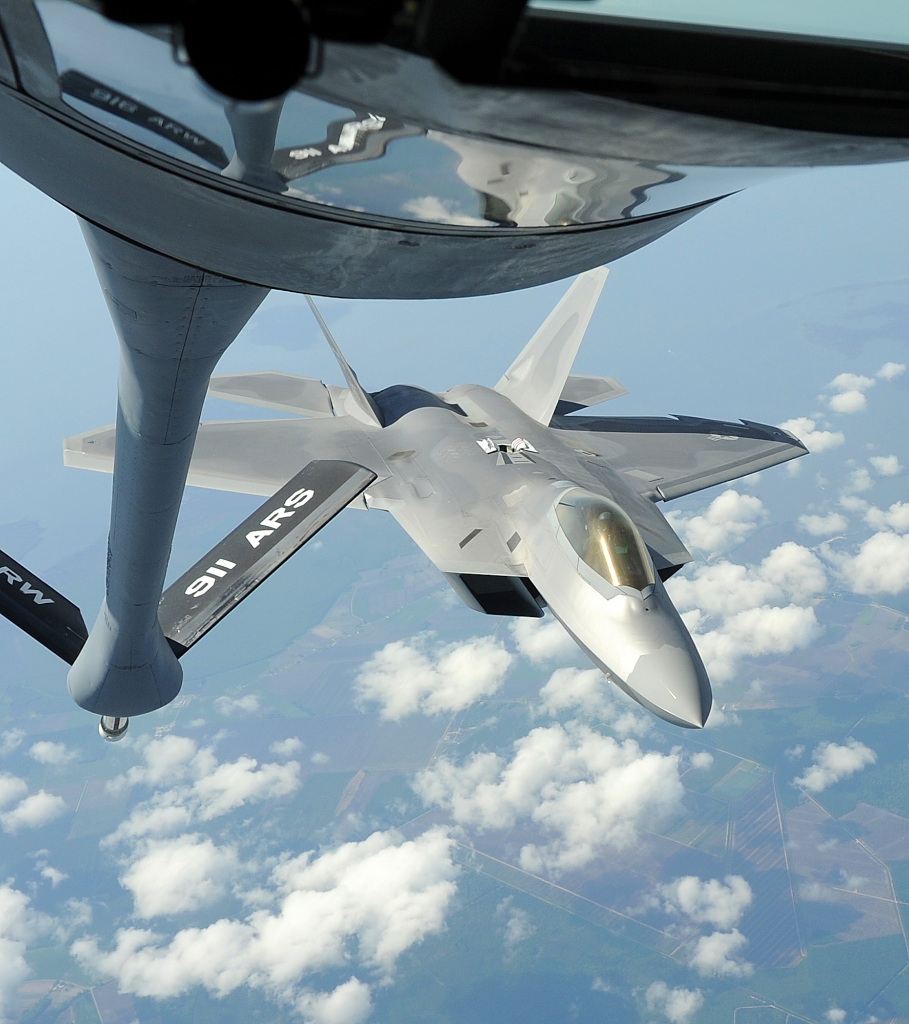 SEYMOUR JOHNSON AIR FORCE BASE, N.C. -- An F-22A Raptor refuels mid-air from a KC-135 Stratotanker during a large force exercise over North Carolina May 2, 2011. The exercise consisted of a strike mission with offensive counter air and suppression-of-enemy-air-defense support. (U.S. Air Force photo/Senior Airman Gino Reyes)