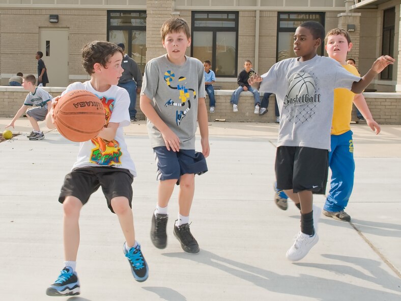 Children play a game of basketball May 2, 2011, at the Dover Air Force Base, Del., Youth Center. The Youth Center is holding a summer camp program June 20 – Aug. 19 to promote both mental and physical activity over the summer months. (U.S. Air Force photo by Adrian Rowan)