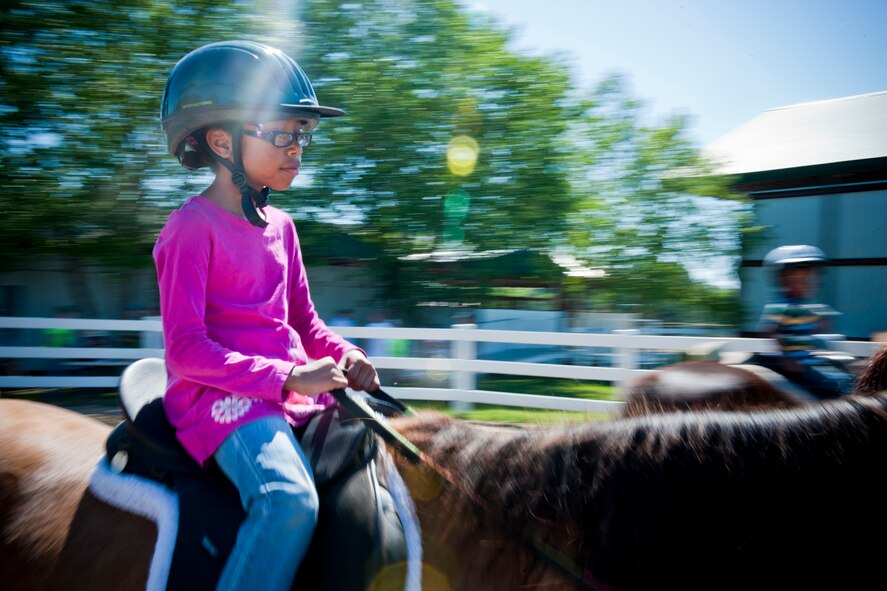 Natalia Williams, daughter of Staff Sgt. Joseph Williams, 23rd Maintenance Operations Squadron, rides a ride April 30 at Jacobs’ Ladder Therapeutic Riding Center in Hahira, Ga. The Moody Integrated Delivery System sponsored the event, giving families with special needs children the opportunity to experience equine therapy. (U.S. Air Force photo/Staff Sgt. Jamal D. Sutter)(RELEASED)