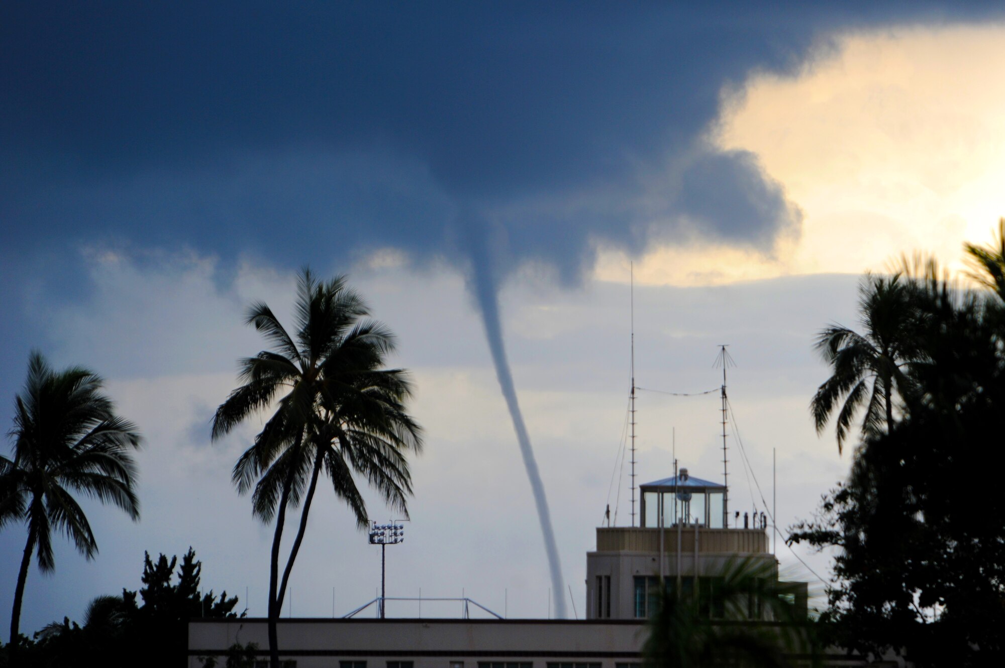 Tall cumulus clouds on the leading edge of a storm off the Southern shore of Oahu May 2, 2011, produced a rare weather sight for the island chain - a water spout. Hickam residents watched while lightning lit up the night sky as the approaching storm eventually swallowed the spout. (U.S. Air Force photo/Staff Sgt. Mike Meares) (RELEASED)   
