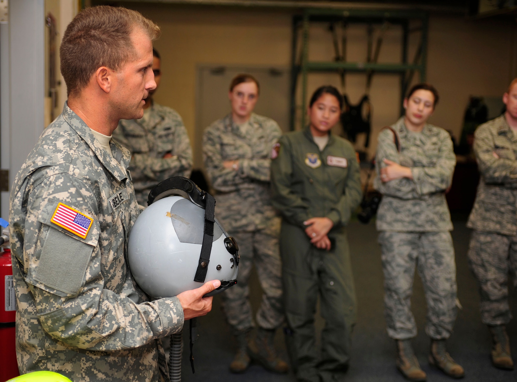 U. S. Army Staff Sgt. Christopher Isbelle, a Joint Communications Support Element parachute rigger, describes the capabilities of parachute equipment to junior officers during the Air Force Company Grade Officer Professional Development Conference tour of the joint parachute facility at MacDill Air Force Base, Fla., May 3, 2011. The conference theme is “Culture-Competence-Leadership; Joint Airmen for Tomorrow’s Battlefield” focusing on providing junior officers with a greater awareness of current operations, the culture and customs of tribal regions in Afghanistan and Pakistan, and the myriad of leadership opportunities in Total Force and joint environments. 
 (U.S. Air Force photo by Senior Airman Linzi Joseph/Released)
