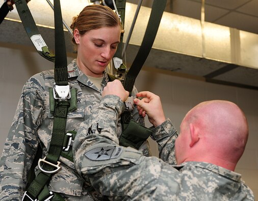 2nd Lt. Lisa Faulkner, the 22nd Operations Group intelligence officer, receives assistance from U.S. Army Sgt. Luke Allen, the Joint Communications Support Element maintenance ncoic of the parachute rigger facility, as she prepares for parachute simulation training during the Air Force Company Grade Officer Professional Development Conference tour of the joint parachute facility at MacDill Air Force Base, Fla., May 3, 2011. The conference theme is “Culture-Competence-Leadership; Joint Airmen for Tomorrow’s Battlefield” focusing on providing junior officers with a greater awareness of current operations, the culture and customs of tribal regions in Afghanistan and Pakistan, and the myriad of leadership opportunities in Total Force and joint environments. 
(U.S. Air Force photo by Senior Airman Linzi Joseph/Released)
