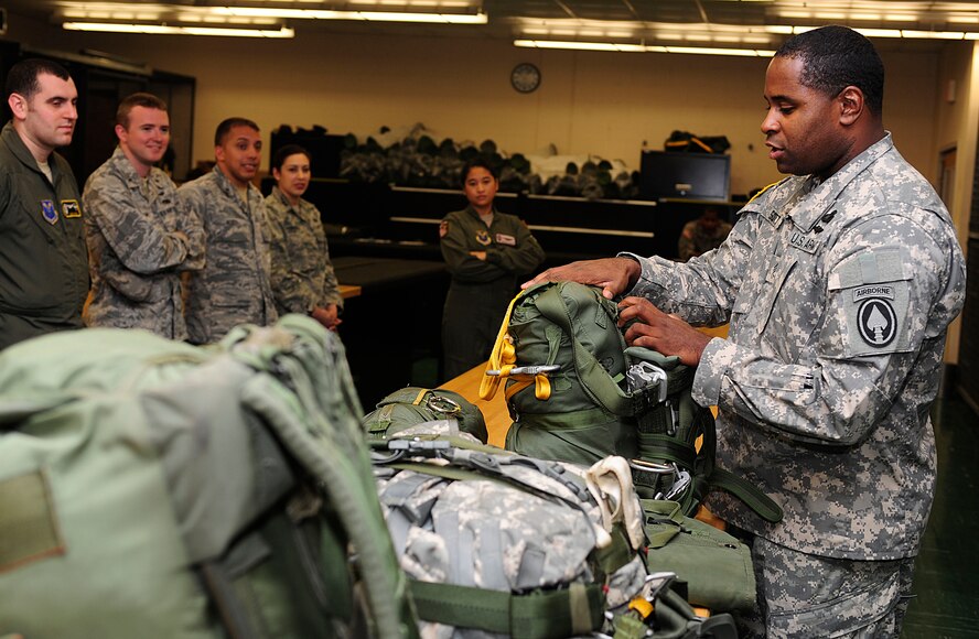 U.S. Army Staff Sgt. Kenneth Scott, a United States Special Operations Command parachute rigger, demonstrates the capabilities of airborne soldiers and their equipment to junior officers during the Air Force Company Grade Officer Professional Development Conference tour of the joint parachute facility at MacDill Air Force Base, Fla., May 3, 2011. The conference theme is “Culture-Competence-Leadership; Joint Airmen for Tomorrow’s Battlefield” focusing on providing junior officers with a greater awareness of current operations, the culture and customs of tribal regions in Afghanistan and Pakistan, and the myriad of leadership opportunities in Total Force and joint environments. 
(U.S. Air Force photo by Senior Airman Linzi Joseph/Released)

