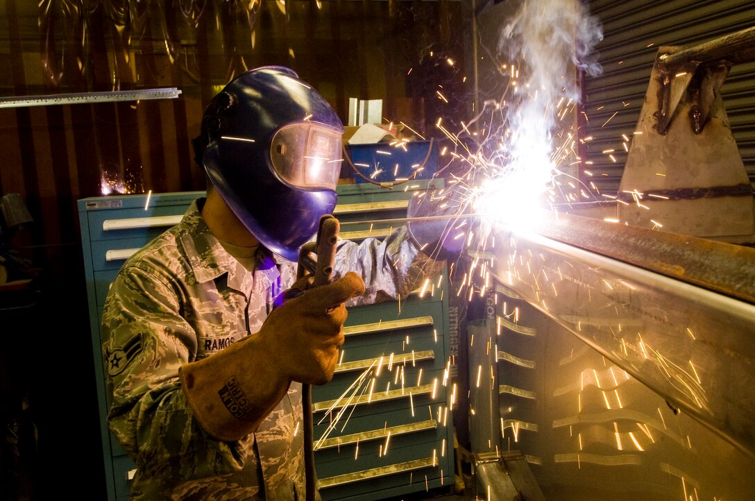 Airman 1st Class David Ramos, 11th Civil Engineer Squadron structural apprentice, Tungsten Inert Gas welds a water tank manufactured for the exterior electrician shop May 2. Airman Ramos was recently awarded the 11 CES “Workhorse of the Month” award for completing the most work orders for the month. (Photo by Bobby Jones) 