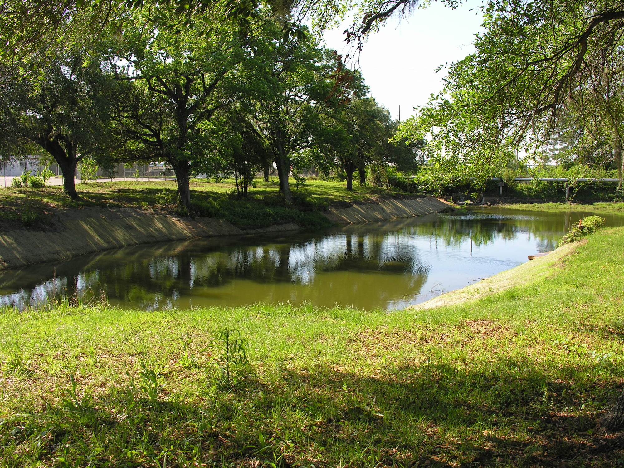 Charlie the alligator, long-time resident of Joint Base Charleston - Weapons Station, moved back into his new home, April 30. His pond has been renovated and includes custom-built, his and her alligator housing in the form of two eight-foot by eight-foot concrete storm water junction boxes buried underground but above the water line. 