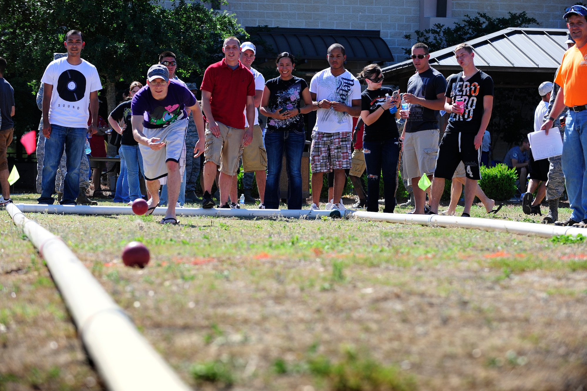 U.S. Air Force Airman 1st Class Kyle Puls, 1st Special Operation Communications Squadron, tosses a Bocce ball during a dormitory picnic hosted by the Fort Walton Beach Military Affairs Committee, Hurlburt Field, Fla., April 28, 2011. Airmen enjoyed playing games, winning prizes and socializing with fellow Air Commandos. (U.S. Air Force photo by Staff Sgt Julianne M. Showalter/Released)
