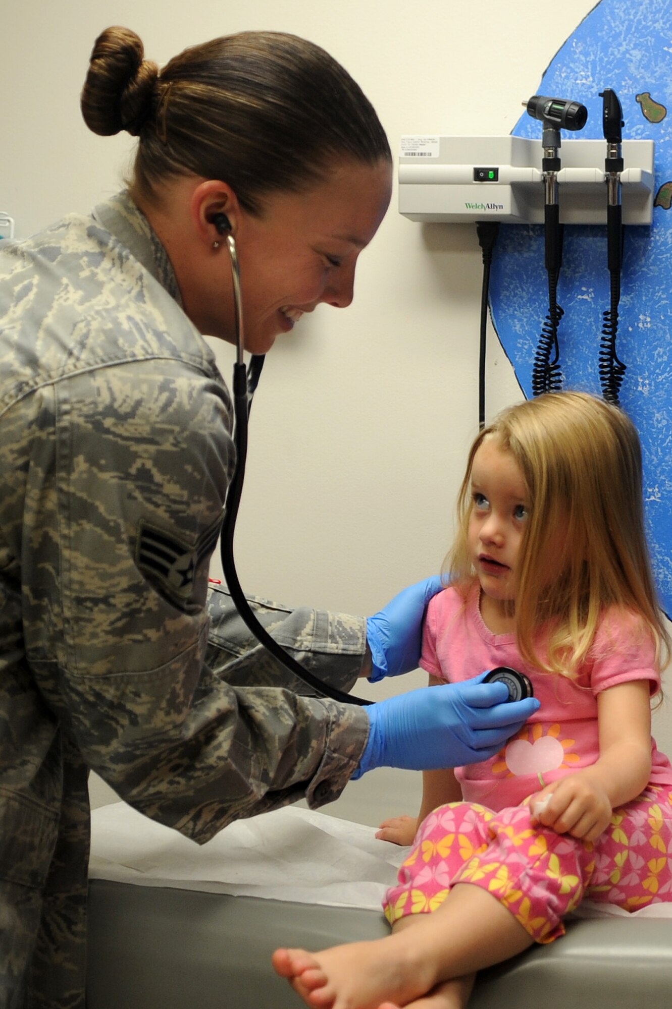 WHITEMAN AIR FORCE BASE, Mo. -- Senior Airman Allison Bell, 509th Medical Operations Squadron pediatrics technician, listens to Kirsten Jamieson's heart beat May 3, 2011. Kirsten, age 2, is the daughter of Capt. Michael Jamieson and Mrs. Jamieson. The 509th Medical Group applauds their hard working nurses and medical technicians during National Nurses and Medical Technician Week. (U.S. Air Force photo by Senior Airman Kenny Holston)(Released)


