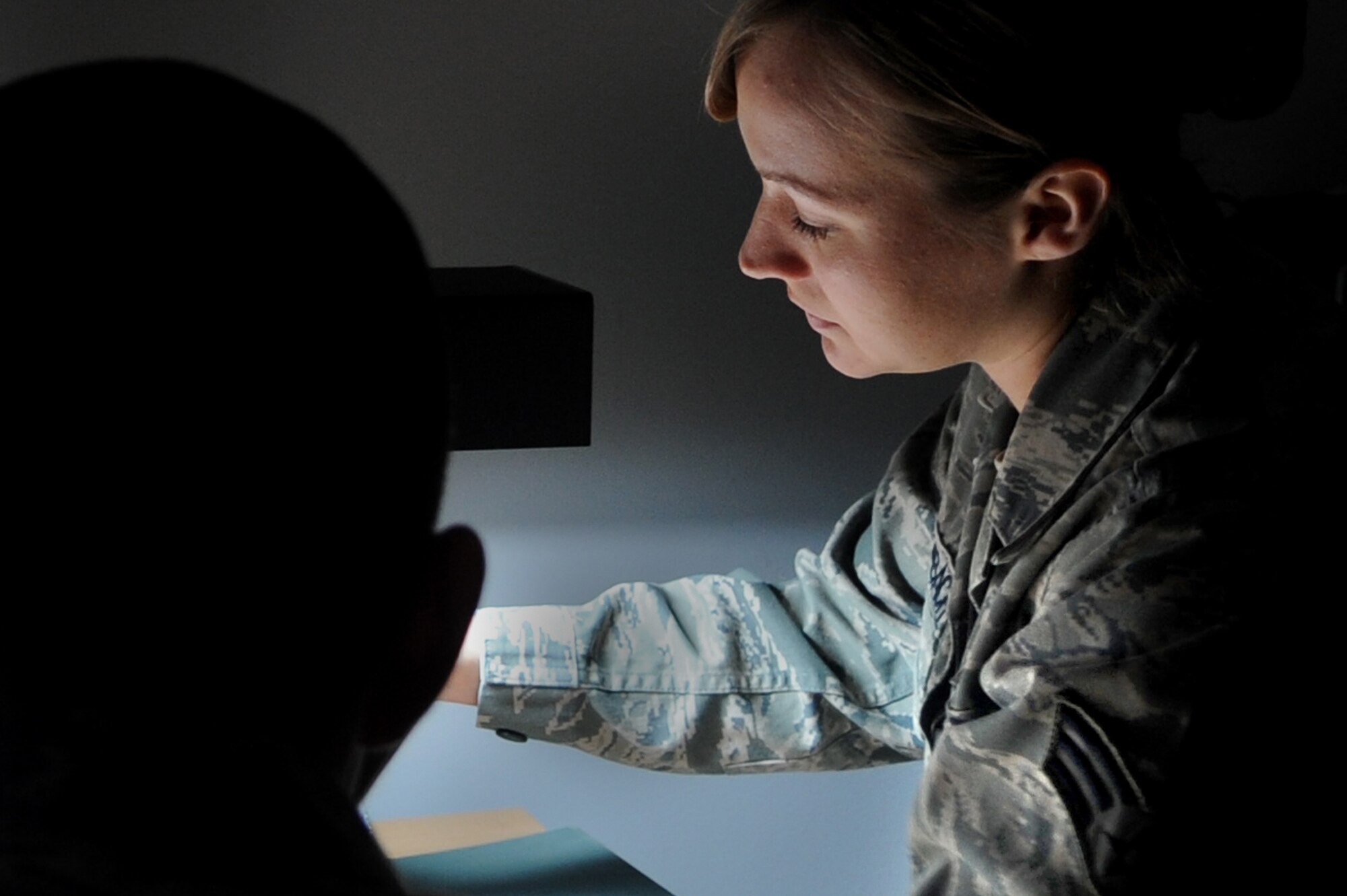 WHITEMAN AIR FORCE BASE, Mo. -- Senior Airman Heather Reidenbach, 509th Medical Operations Squadron flight medicine technician, administers an eye exam to a patient May 3, 2011. The 509th Medical Group applauds their hard working nurses and medical technicians during National Nurses and Medical Technician Week. (U.S. Air Force photo by Senior Airman Kenny Holston)(Released)



