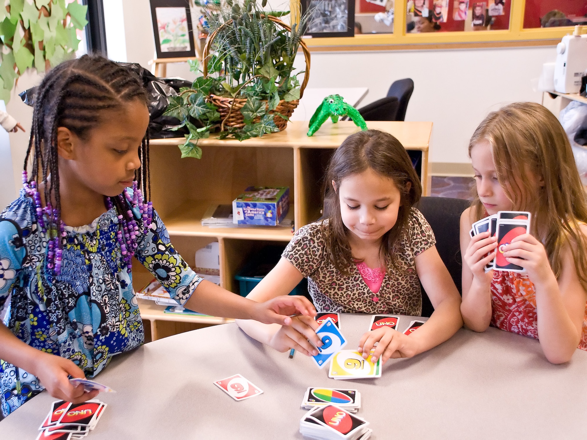 Asaiah Jones (left) plays a card game with Karalyne Handley and CourDe’ Walston May 2, 2011, at the Dover Air Force Base, Del., Youth Center. The Youth Center is holding a summer camp program June 20 – Aug. 19 and will offer varied trips to its attendees such as Washington D.C. and local attractions. (U.S. Air Force photo by Adrian Rowan)