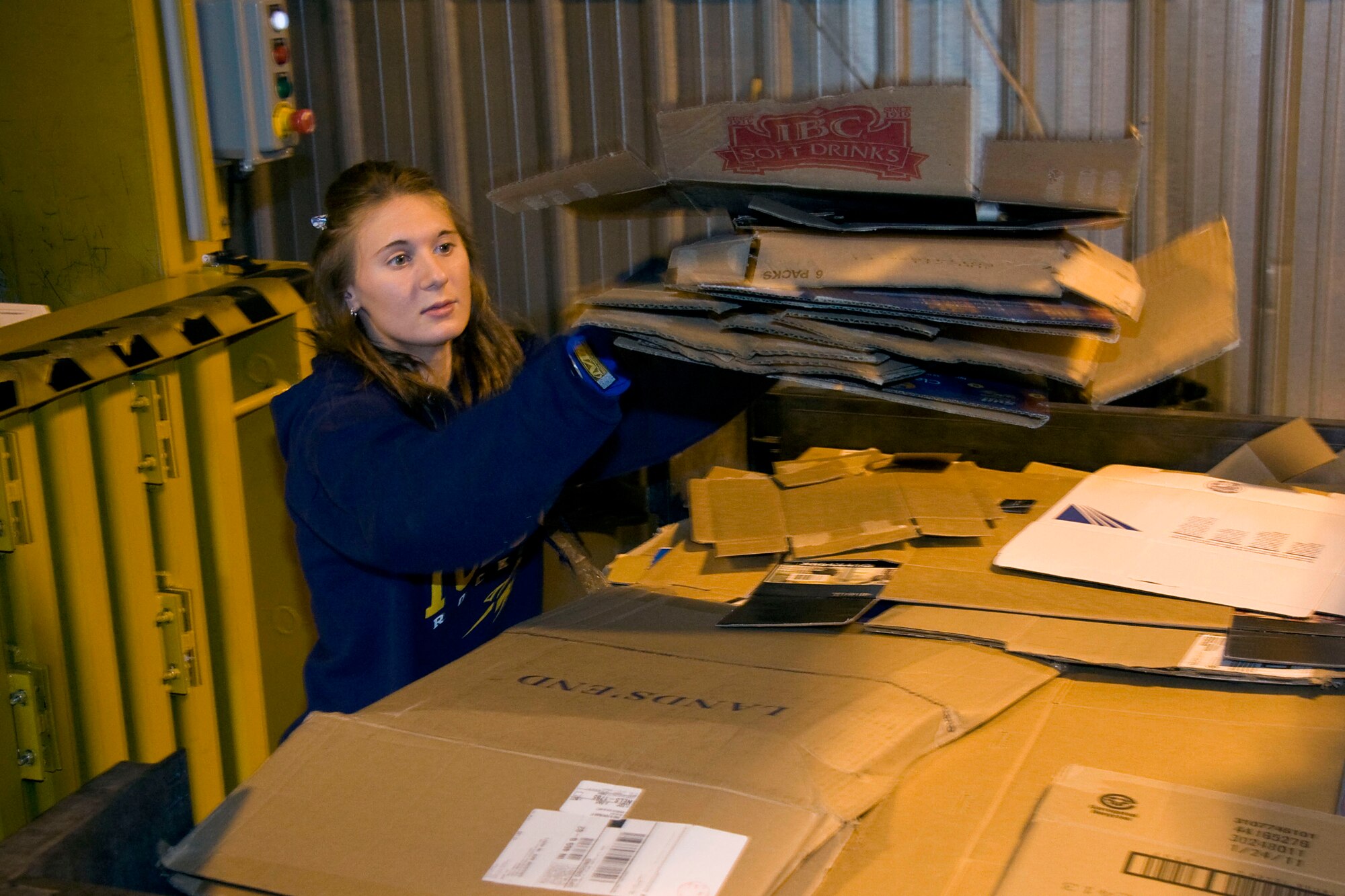 GRISSOM AIR RESERVE BASE, Ind. -- Lisa Maynard lifts cardboard from a recycling bin before throwing it into a compactor May 2. The cardboard will be crushed, baled and shipped away for recycling. In 2010, the base recycled more than 174 tons of material including 91 tons of scrap metal, 48 tons of cardboard, 29 tons of paper and 2 tons of used tires. Ms. Maynard is a laborer with the 434th Civil Engineer Squadron. (U.S. Air Force photo/Tech. Sgt. Mark R. W. Orders-Woempner)
