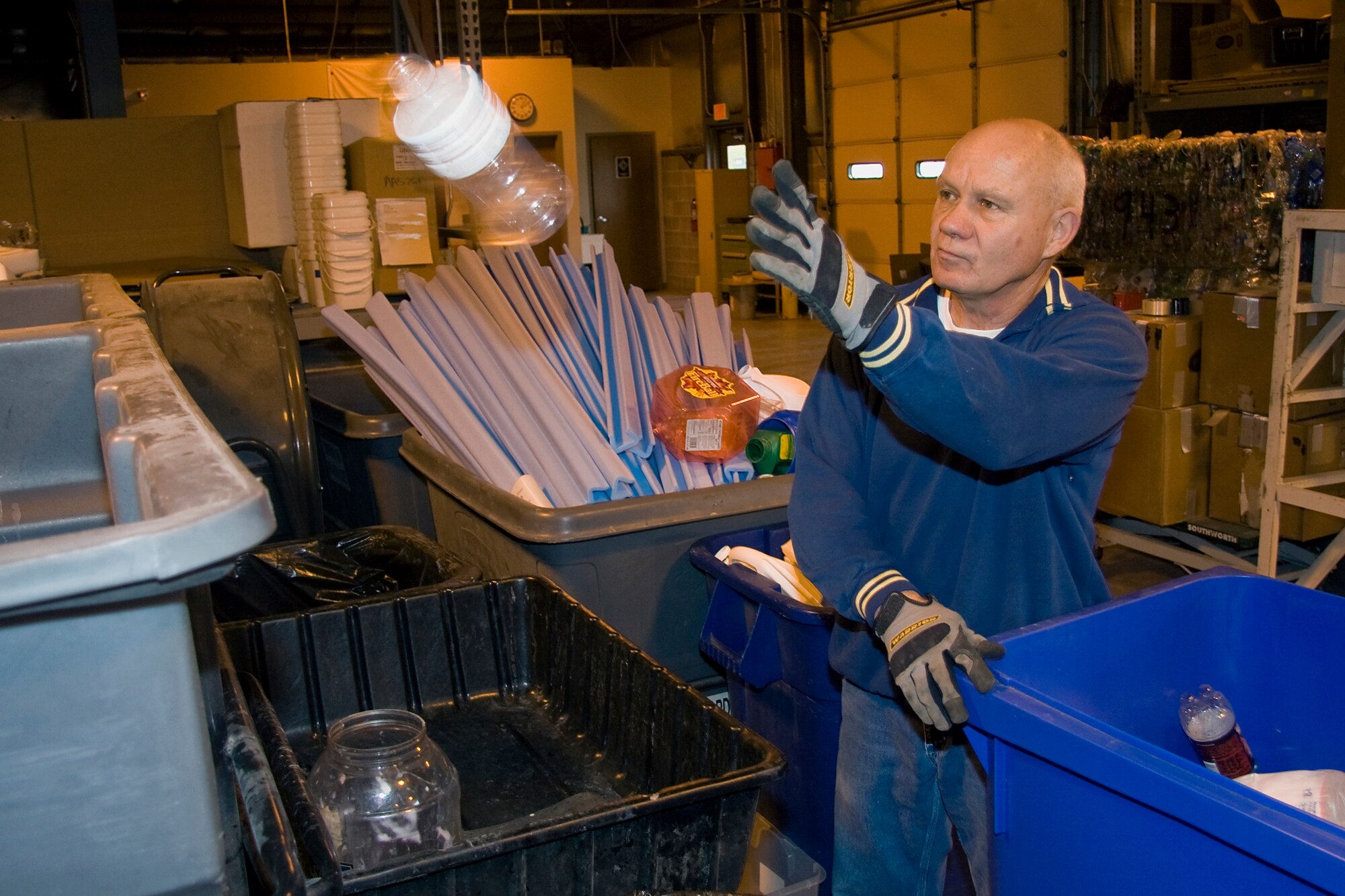 GRISSOM AIR RESERVE BASE, Ind. -- Dan Miller, 434th Civil Engineer Squadron general services and support worker, tosses a bottle as he sorts through plastics meant for recycling May 2. In 2010, the base recycled more than 174 tons of material including 91 tons of scrap metal, 48 tons of cardboard, 29 tons of paper and 2 tons of used tires. The recycling program alone netted almost $23,000 last year, which is used to buy new equipment, supplies and promotional items. (U.S. Air Force photo/Tech. Sgt. Mark R. W. Orders-Woempner)
