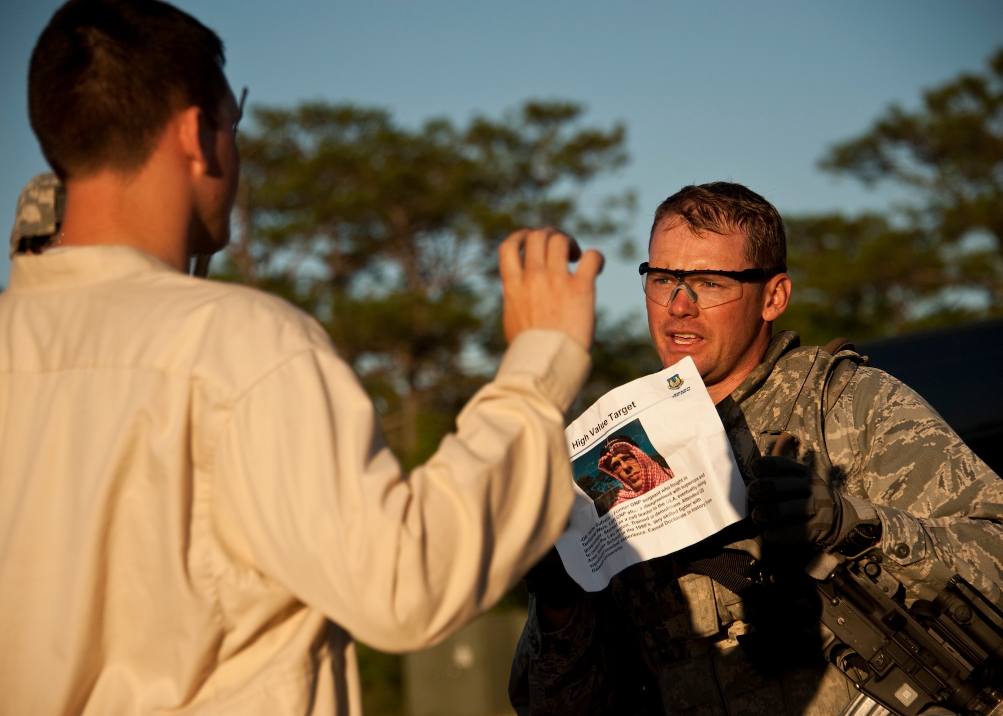 Maj. Justin Oldt, 99th Mission Support Group, asks a suspect about a high value target his squad has been looking for during an exercise April 29 at Eglin Air Force Base, Fla.  This was part of Air Force Materiel Command’s "Brave Defender" training, which is administered by the 96th Ground Combat Training Squadron.  GCTS instructors push 10 training classes a year, which consists of improvised explosive device detection and reaction, operating in an urban environment, mission planning, land navigation and casualty care.  The three-week training culminates with a three-day field training exercise where the Airmen apply what they learned in combat scenarios.  More than 140 Airmen from more than 10 locations attended this training.  (U.S. Air Force photo/Samuel King Jr.)