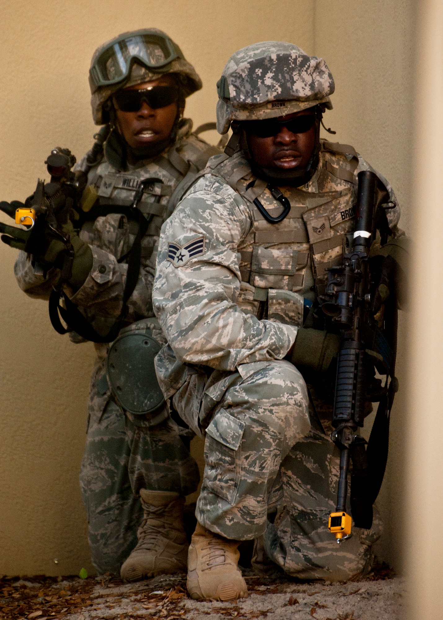 Senior Airmen Bobby Brown and Crystal Williams, 375th Security Forces Squadron, take cover before advancing through the village during an exercise April 29 at Eglin Air Force Base, Fla.  Based on intelligence gathered, two squads entered the village in search of a high value target.  This was part of Air Force Materiel Command’s "Brave Defender" training, which is administered by the 96th Ground Combat Training Squadron.  GCTS instructors push 10 training classes a year, which consists of improvised explosive device detection and reaction, operating in an urban environment, mission planning, land navigation and casualty care.  The three-week training culminates with a three-day field training exercise where the Airmen apply what they learned in combat scenarios.  More than 140 Airmen from more than 10 locations attended this training.  (U.S. Air Force photo/Samuel King Jr.)