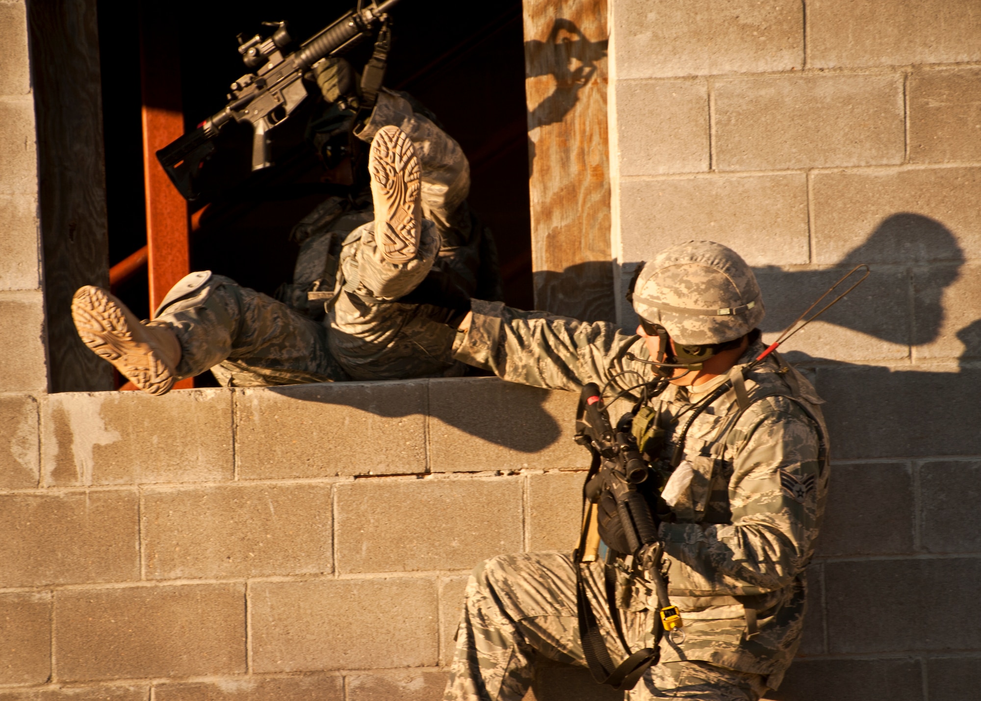 Airmen go through a window to gain entry into a building during a raid on a village as part of an exercise April 29 at Eglin Air Force Base, Fla.  Based on intelligence gathered, two squads entered the village in search of a high value target.  This was part of Air Force Materiel Command’s "Brave Defender" training, which is administered by the 96th Ground Combat Training Squadron.  GCTS instructors push 10 training classes a year, which consists of improvised explosive device detection and reaction, operating in an urban environment, mission planning, land navigation and casualty care.  The three-week training culminates with a three-day field training exercise where the Airmen apply what they learned in combat scenarios.  More than 140 Airmen from more than 10 locations attended this training.  (U.S. Air Force photo/Samuel King Jr.)