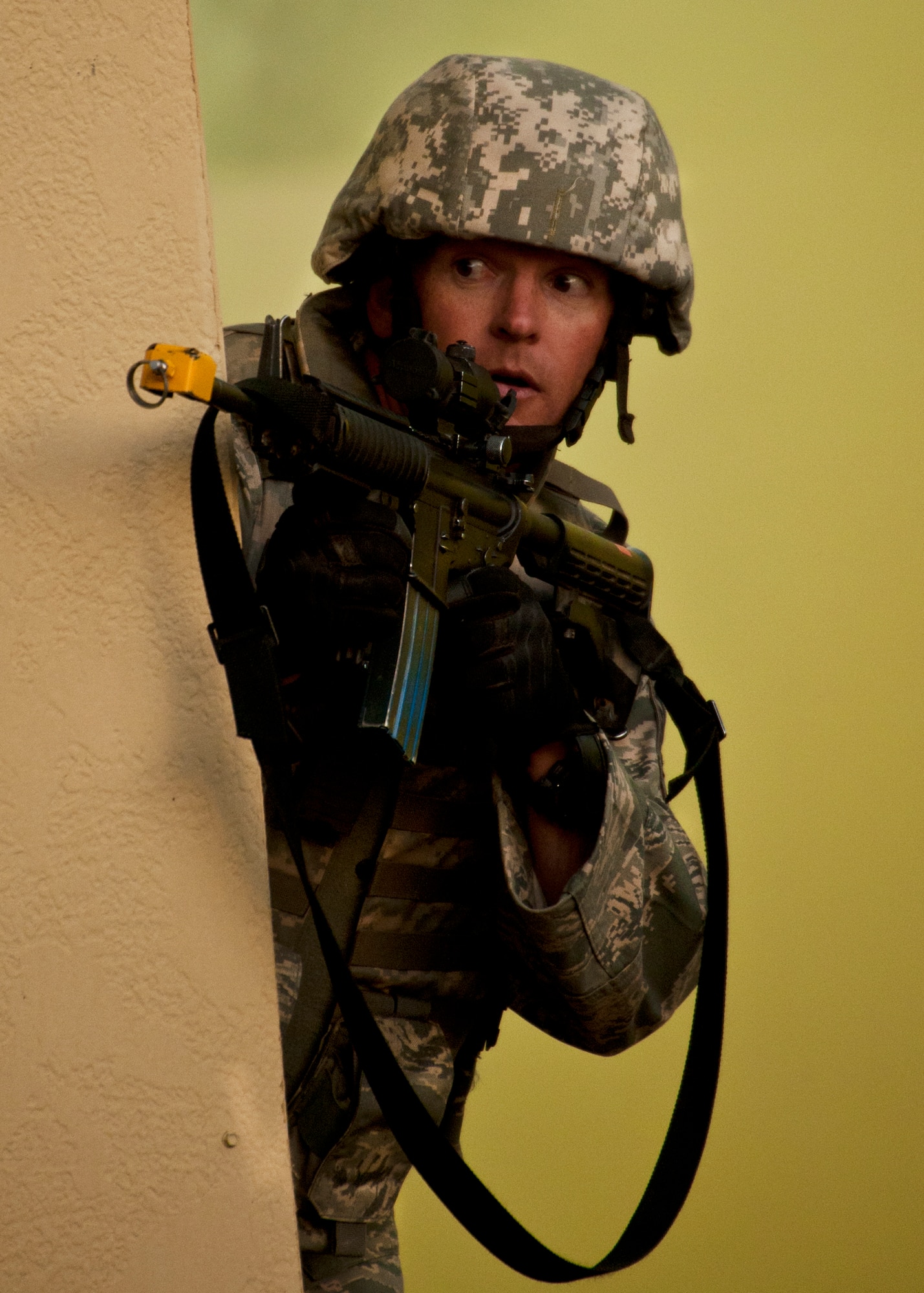 Tech. Sgt. Sloan Cox, 375th Security Forces Squadron, looks for enemy movement during a firefight in a village as part of an exercise April 29 at Eglin Air Force Base, Fla.  Based on intelligence gathered, two squads entered the village in search of a high value target.  This was part of Air Force Materiel Command’s "Brave Defender" training, which is administered by the 96th Ground Combat Training Squadron.  GCTS instructors push 10 training classes a year, which consists of improvised explosive device detection and reaction, operating in an urban environment, mission planning, land navigation and casualty care.  The three-week training culminates with a three-day field training exercise where the Airmen apply what they learned in combat scenarios.  More than 140 Airmen from more than 10 locations attended this training.  (U.S. Air Force photo/Samuel King Jr.)