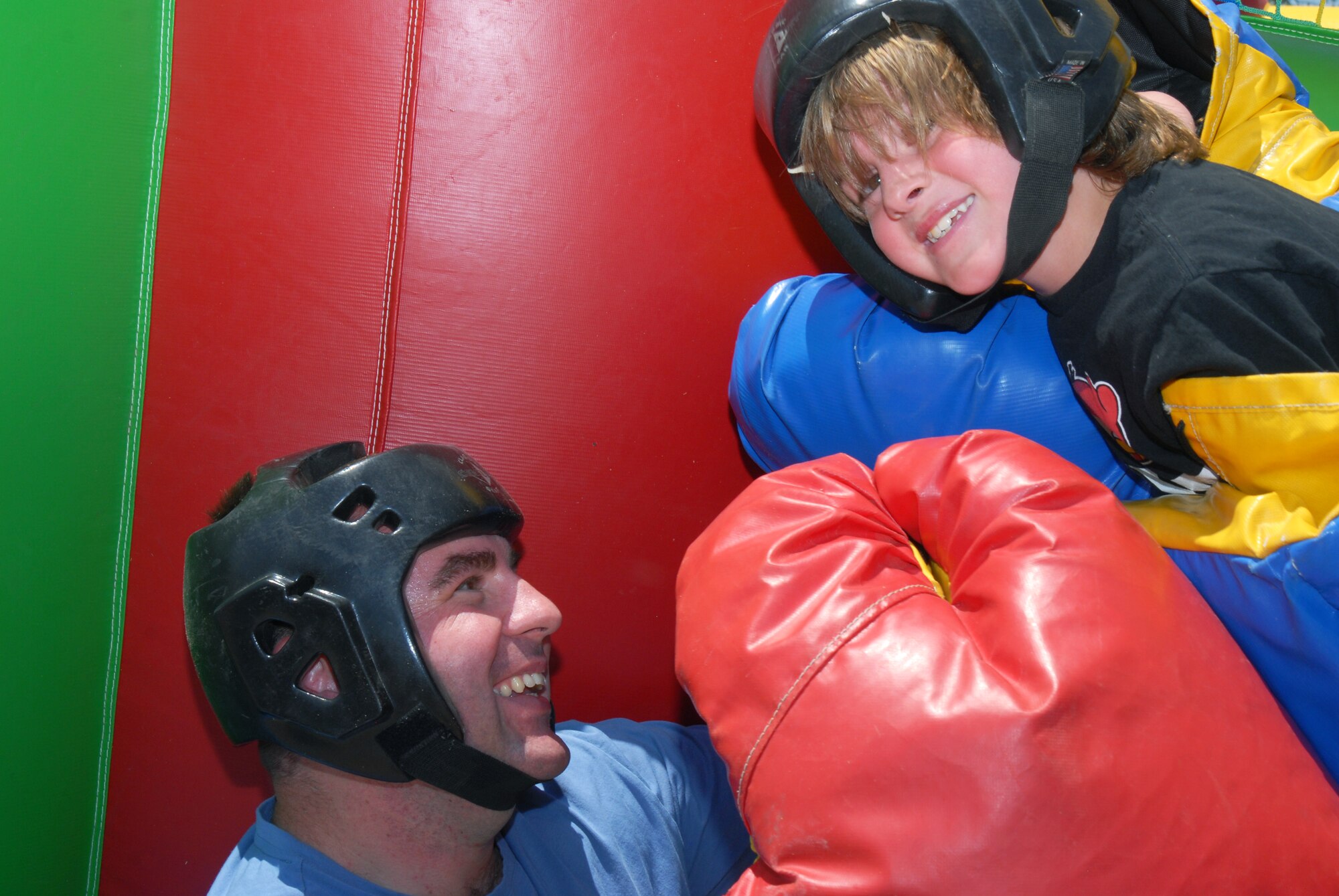 U.S. Army Sgt. 1st Class William Tannler, 344th Military Intelligence Battalion, has a boxing match with his son Riley Tannler at the Children's Festival, April 30. The Children's Festival had many games and attractions for families. (U.S. Air Force photo/Airman 1st Class Michael Smith)