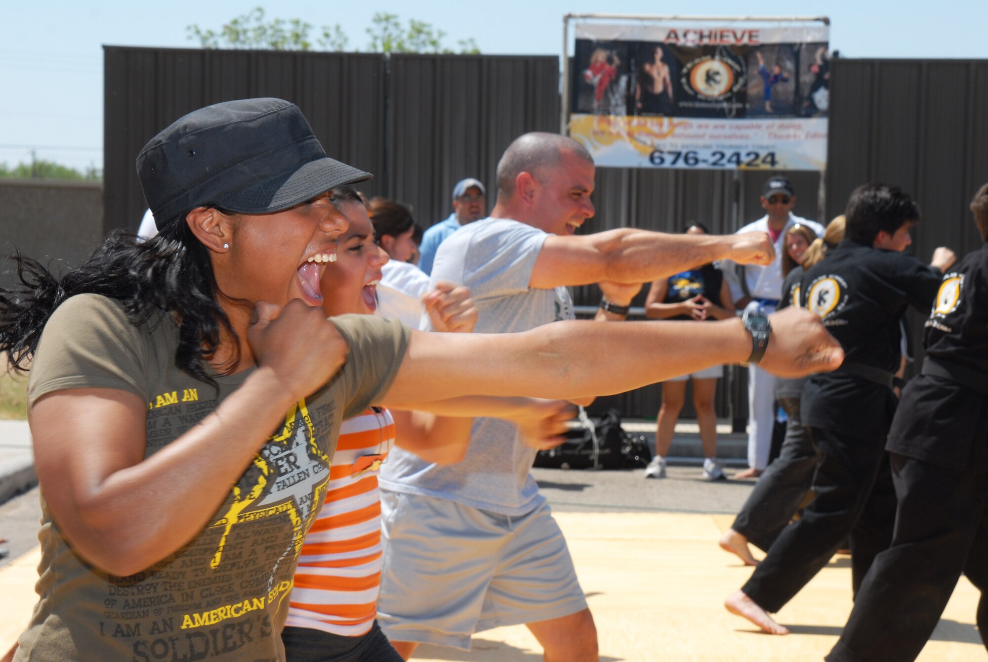 U.S. Army Spc. Carla Serrano joins along with Team Chip Taekwondo during different exercises at the Children's Festival, April 30. Serrano quicky learned that martail arts is harder than it looks. (U.S. Air Force photo/Airman 1st Class Michael Smith)