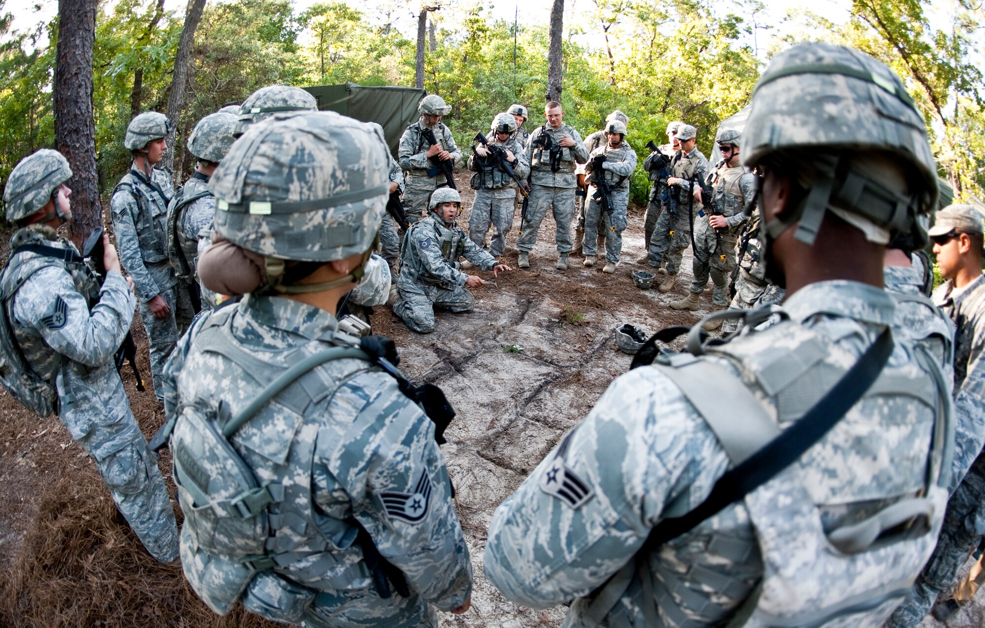Tech. Sgt. Jaime Correa, 17th Security Forces Squadron, briefs his squad on the plan to assault a village after an attack on their base April 29 at Eglin Air Force Base, Fla.  Based on intelligence gathered, two squads entered the village in search of a high value target.  This was part of Air Force Materiel Command’s "Brave Defender" training, which is administered by the 96th Ground Combat Training Squadron.  GCTS instructors push 10 training classes a year, which consists of improvised explosive device detection and reaction, operating in an urban environment, mission planning, land navigation and casualty care.  The three-week training culminates with a three-day field training exercise where the Airmen apply what they learned in combat scenarios.  More than 140 Airmen from more than 10 locations attended this training.  Sergeant Correa won the Lt. Joseph Helton Leadership Award the following day at graduation.  (U.S. Air Force photo/Samuel King Jr.)