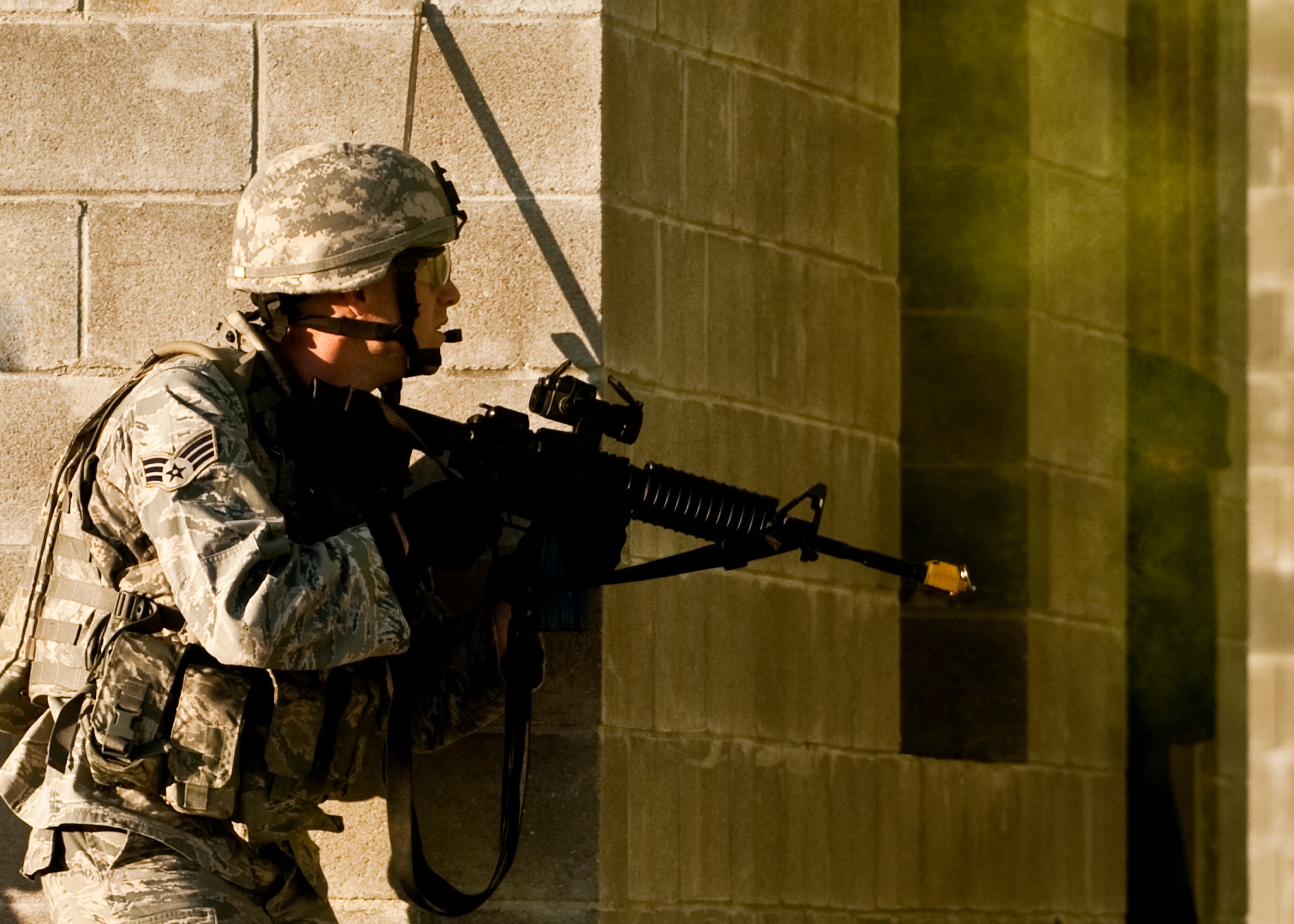A security forces Airman moves around the corner as a “local villager” peeks out of her home during an exercise April 29 at Eglin Air Force Base, Fla.  The squad entered the village searching for a high value target.  This was part of Air Force Materiel Command’s "Brave Defender" training, which is administered by the 96th Ground Combat Training Squadron.  GCTS instructors push 10 training classes a year, which consists of improvised explosive device detection and reaction, operating in an urban environment, mission planning, land navigation and casualty care.  The three-week training culminates with a three-day field training exercise where the Airmen apply what they learned in combat scenarios.  More than 140 Airmen from more than 10 locations attended this training.  (U.S. Air Force photo/Samuel King Jr.)