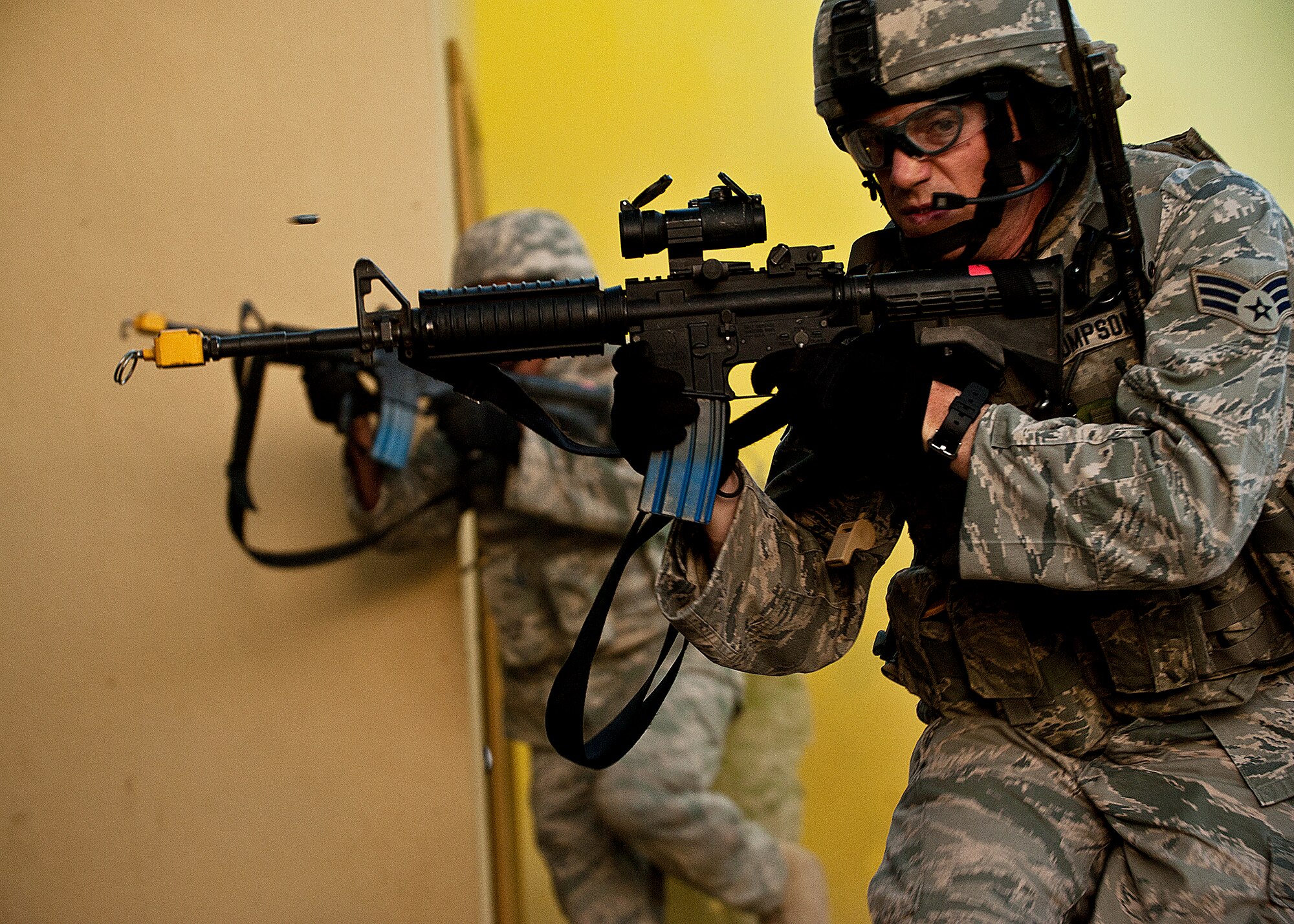 Senior Airman Benjamin Thompson, 375th Security Forces Squadron, opens fire as he moves away from the building during a raid on a village as part of an exercise April 29 at Eglin Air Force Base, Fla.  Based on intelligence gathered, two squads entered the village in search of a high value target.  This was part of Air Force Materiel Command’s "Brave Defender" training, which is administered by the 96th Ground Combat Training Squadron.  GCTS instructors push 10 training classes a year, which consists of improvised explosive device detection and reaction, operating in an urban environment, mission planning, land navigation and casualty care.  The three-week training culminates with a three-day field training exercise where the Airmen apply what they learned in combat scenarios.  More than 140 Airmen from more than 10 locations attended this training.  (U.S. Air Force photo/Samuel King Jr.)