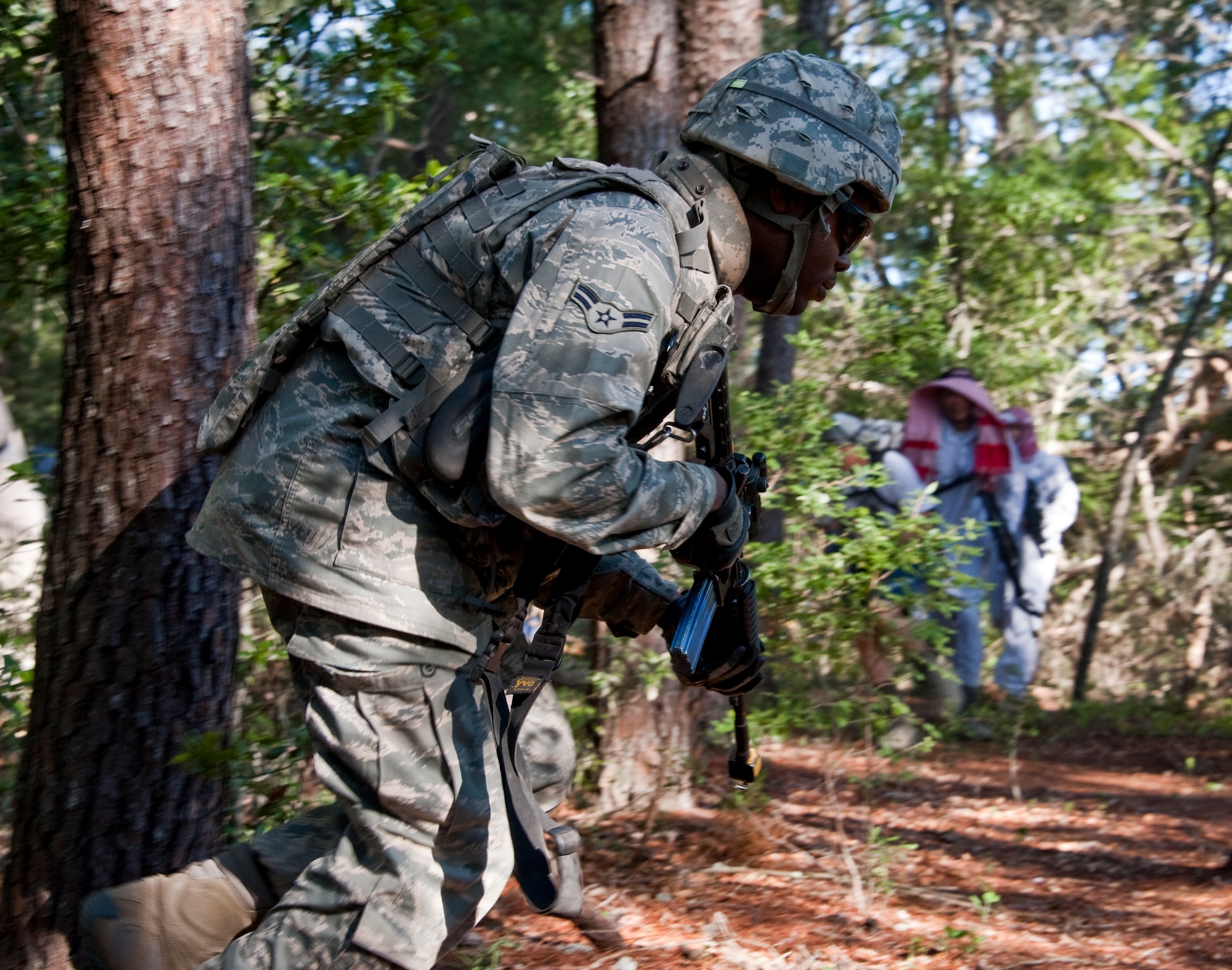 A security forces Airman moves to a better position as enemy forces enter the base as part of an exercise April 29 at Eglin Air Force Base, Fla.  This was part of Air Force Materiel Command’s "Brave Defender" training, which is administered by the 96th Ground Combat Training Squadron.  GCTS instructors push 10 training classes a year, which consists of improvised explosive device detection and reaction, operating in an urban environment, mission planning, land navigation and casualty care.  The three-week training culminates with a three-day field training exercise where the Airmen apply what they learned in combat scenarios.  More than 140 Airmen from more than 10 locations attended this training.  (U.S. Air Force photo/Samuel King Jr.)