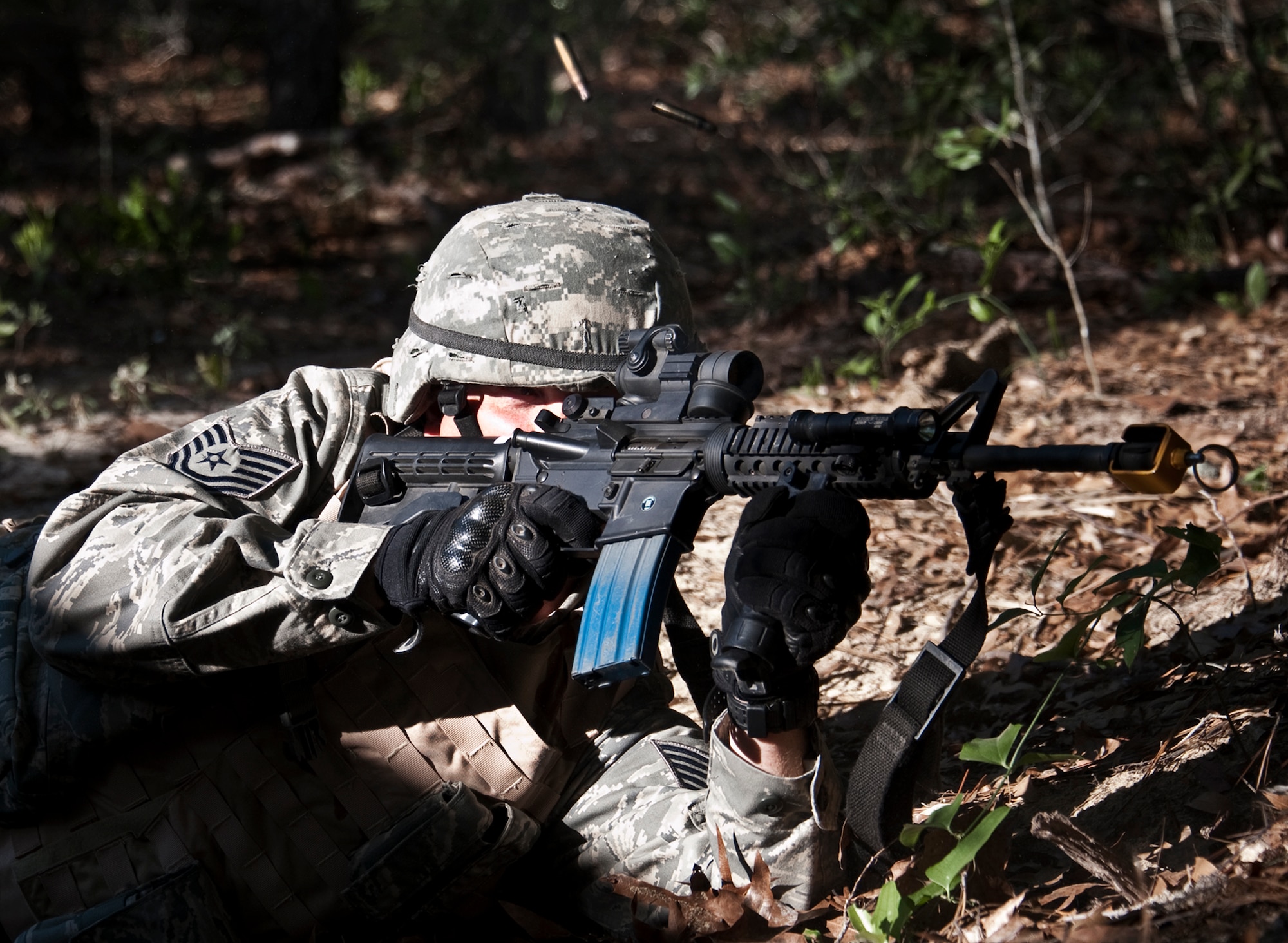 Tech. Sgt. Paul Rubusch returns fire as “simulated” enemies storm the base and move closer to the command center as part of an exercise April 29 at Eglin Air Force Base, Fla.  This was part of Air Force Materiel Command’s "Brave Defender" training, which is administered by the 96th Ground Combat Training Squadron.  GCTS instructors push 10 training classes a year, which consists of improvised explosive device detection and reaction, operating in an urban environment, mission planning, land navigation and casualty care.  The three-week training culminates with a three-day field training exercise where the Airmen apply what they learned in combat scenarios.  More than 140 Airmen from more than 10 locations attended this training.  (U.S. Air Force photo/Samuel King Jr.)