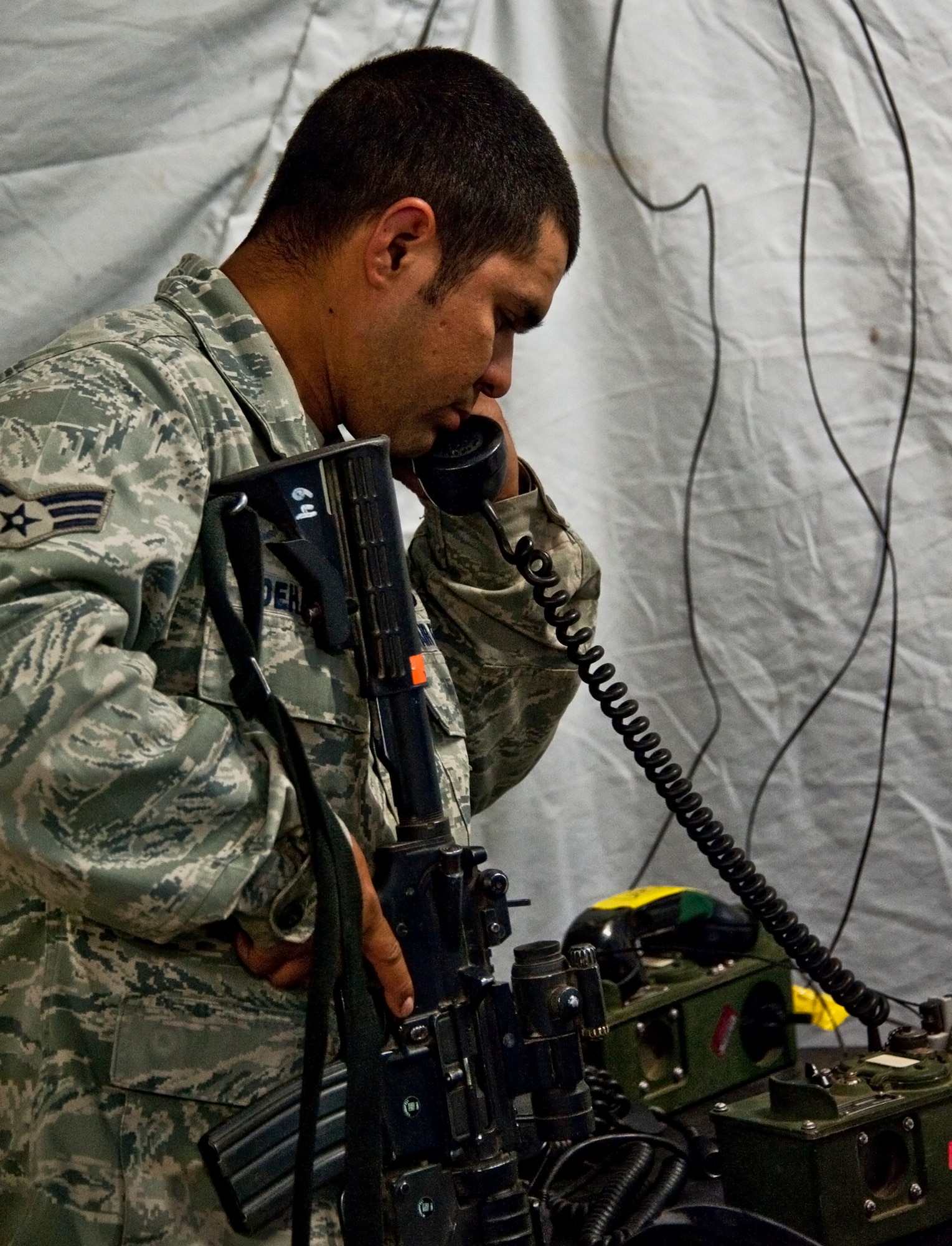 A security forces Airman in the command center calls for a status report after a “simulated” attack on their base as part of an exercise April 29 at Eglin Air Force Base, Fla.  This was part of Air Force Materiel Command’s "Brave Defender" training, which is administered by the 96th Ground Combat Training Squadron.  GCTS instructors push 10 training classes a year, which consists of improvised explosive device detection and reaction, operating in an urban environment, mission planning, land navigation and casualty care.  The three-week training culminates with a three-day field training exercise where the Airmen apply what they learned in combat scenarios.  More than 140 Airmen from more than 10 locations attended this training.  (U.S. Air Force photo/Samuel King Jr.)