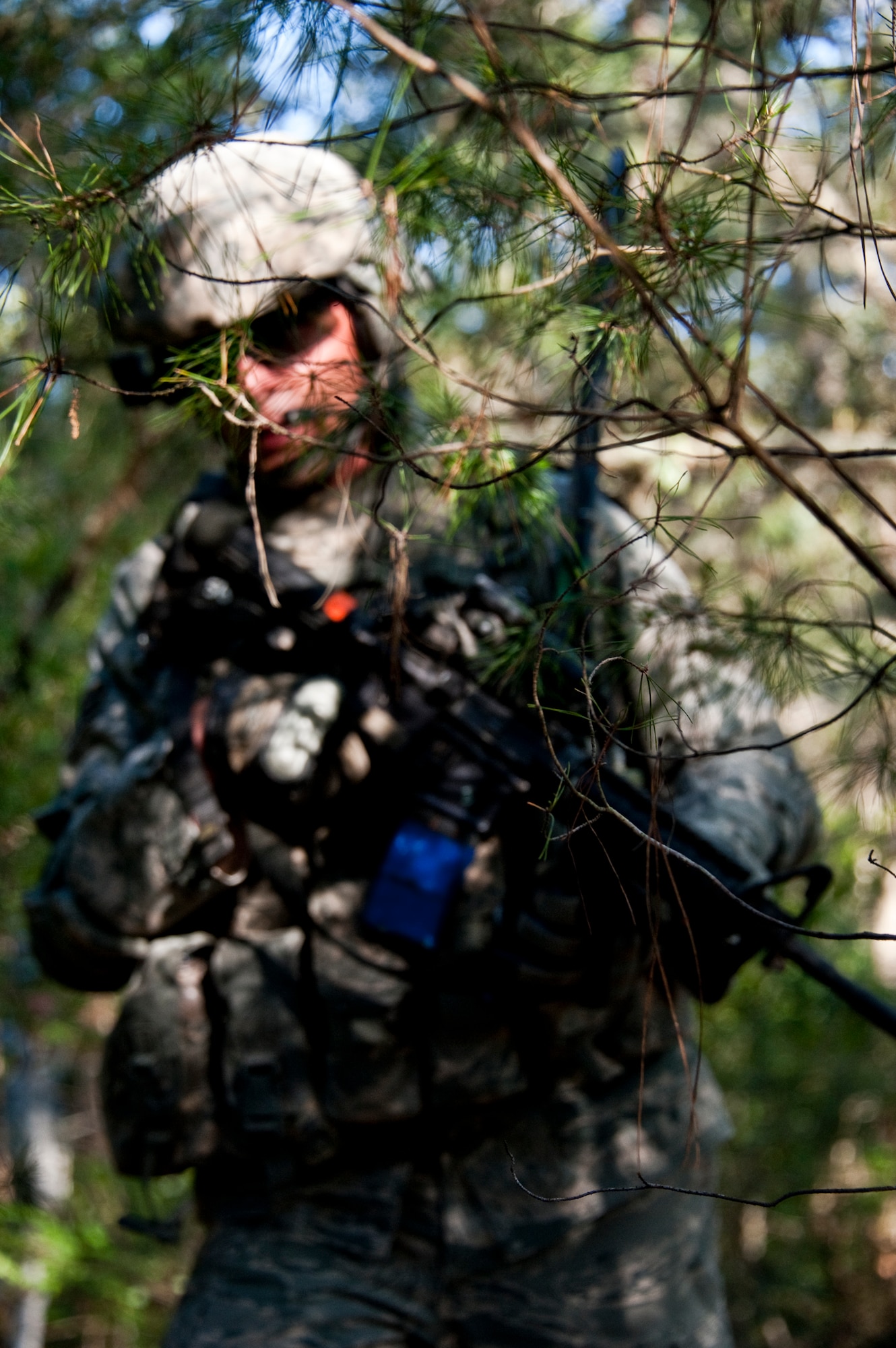 A security forces Airman moves through thick brush during a patrol after a “simulated” attack on their base as part of an exercise April 29 at Eglin Air Force Base, Fla.  This was part of Air Force Materiel Command’s "Brave Defender" training, which is administered by the 96th Ground Combat Training Squadron.  GCTS instructors push 10 training classes a year, which consists of improvised explosive device detection and reaction, operating in an urban environment, mission planning, land navigation and casualty care.  The three-week training culminates with a three-day field training exercise where the Airmen apply what they learned in combat scenarios.  More than 140 Airmen from more than 10 locations attended this training.  (U.S. Air Force photo/Samuel King Jr.)