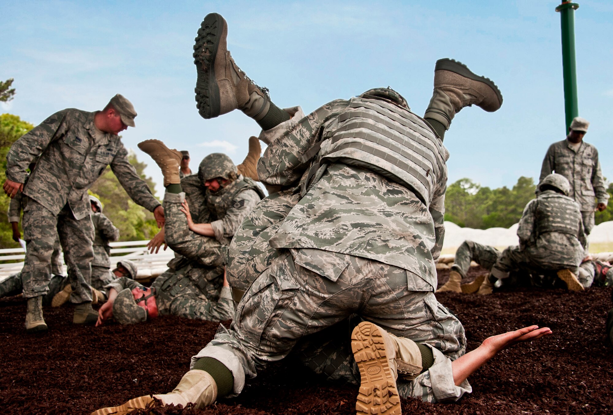 Security forces Airmen practice take down and grappling maneuvers during a hand-to-hand combat class April 14 at Eglin Air Force Base, Fla.  This, along with the new Fly Away Security Team training were included in Air Force Materiel Command’s "Brave Defender" training,  which is administered by the 96th Ground Combat Training Squadron.  Although not part of the overall course, GCTS provided the specialized training to those Airmen who were required to have it prior to deploying.   More than 140 Airmen from more than 12 locations attended the three-week course.  (U.S. Air Force photo/Samuel King Jr.)  