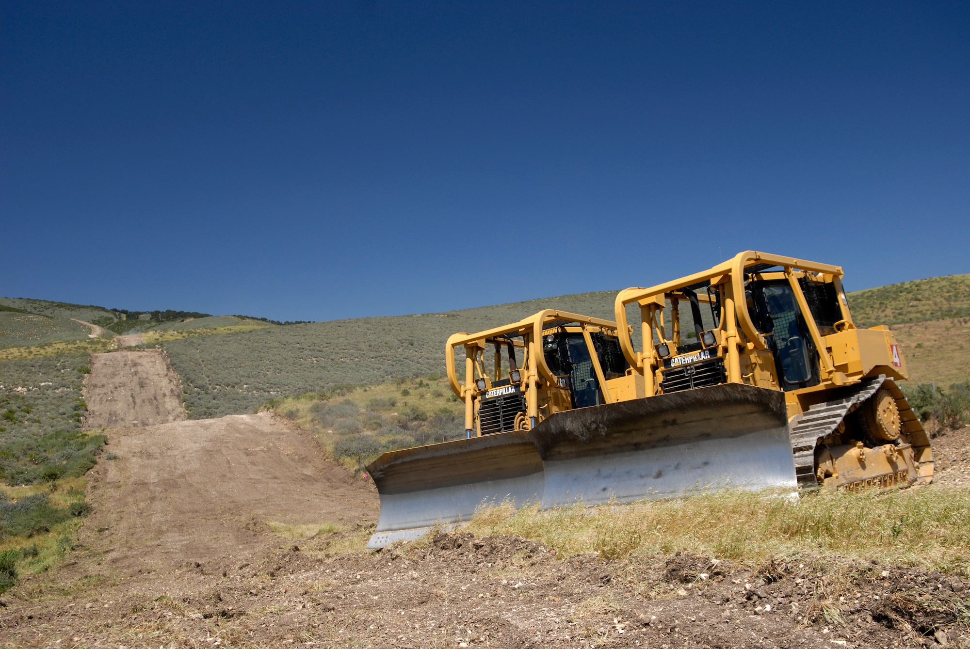 VANDENBERG AIR FORCE BASE, Calif. -- Two bulldozers wait to be used during the Fire Dozer Academy training here Thursday, April 28, 2011.  (U.S. Air Force photo/Staff Sgt. Andrew Satran) 

 