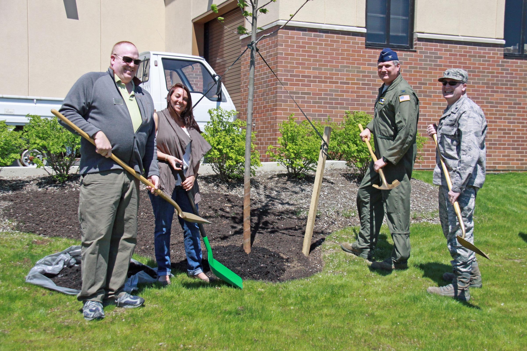 From left, Darren Mayfield, Manager of 911th Club Cargo Bay; Senior Airman Keely Bunting, Equipment Management, 911th Logistics Readiness Squadron; Col. Daryl Hartman, 911th Operations Group commander; and Lt. Col. Patrick Ryan, 911th Mission Support Group commander, finish planting a tree during the Earth Day observance April 28, 2011 at the 911th Airlift Wing. To commemorate Earth Day, each year the 911th Airlift Wing plants a tree to symbolize the commitment to environmental stewardship. This year marks the 16th annual ceremony. (U.S. Air Force photo/Staff Sgt. Jamie L. Perry)