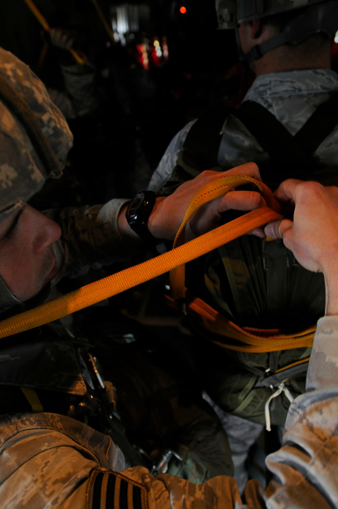 U.S. Air Force Staff Sgt. Joseph Klimaski, secures a static line to Staff Sgt. Nickolas Hurst's parachute, both from the 435th Security Forces Squadron, during Thracian Spring 2011, Plovdiv, Bulgaria, April 29, 2011. Thracian Spring 2011 is a two week on-site training designed to build partnerships between the U.S. and Bulgarian Air Force. (U.S. Air Force photo by Airman 1st Class Desiree W. Esposito)