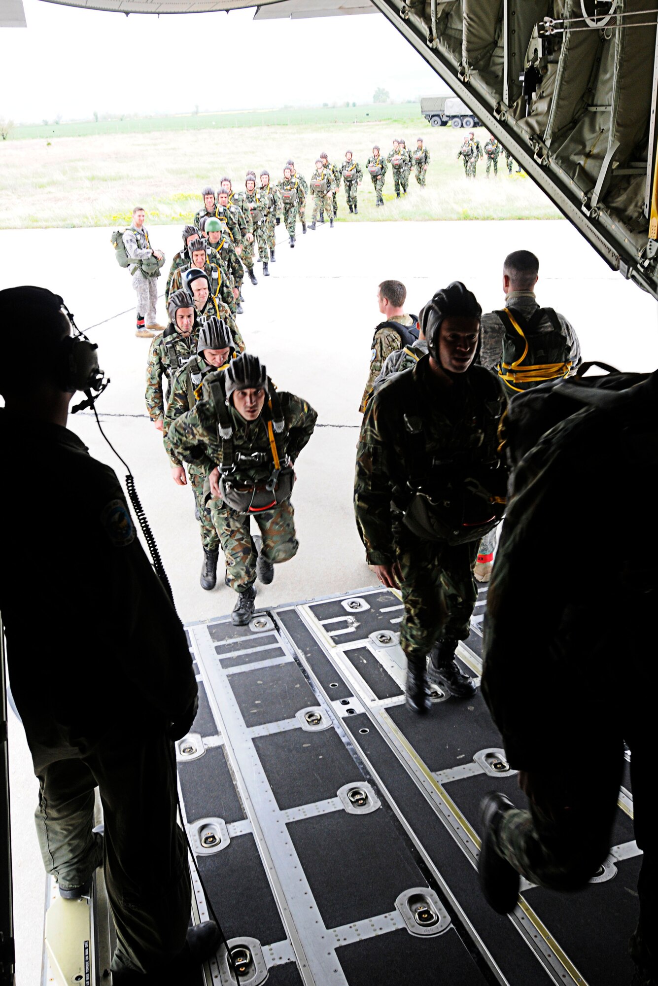 U.S. Air Force 435th Security Forces Squadron members usher in more than 50 Bulgarian Air Force paratroopers into a C-130J Super Hercules in support of Thracian Spring 2011, Plovdiv, Bulgaria, April 29, 2011. Thracian Spring 2011 is a two week on-site training designed to build partnerships between the U.S. and Bulgarian Air Force. (U.S. Air Force photo by Airman 1st Class Desiree W. Esposito)