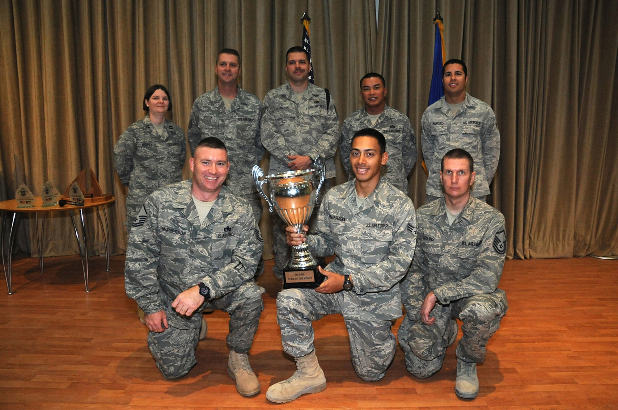 Front row from left: Master Sgt. Boyce McPherson, Senior Airman Kenny Gonzalez and Master Sgt. James Collins all part of the 387th Expeditionary Logistics Readiness Squadron convoy team, which was named Team of the Month. Back row from left: Capt. Rebekah Mooney, Company Grade Officer of the Month; Master Sgt. James Crosson, Senior Noncommissioned Officer of the Month; Tech Sgt. John Mason, Ceremonial Honor Guardsman of the Month; Staff Sgt. Ronald Cruz, NCO of the Month and Senior Airman Omar Marrero, Airman of the Month. (U.S. Air Force photo by Senior Airman Cynthia Spalding)