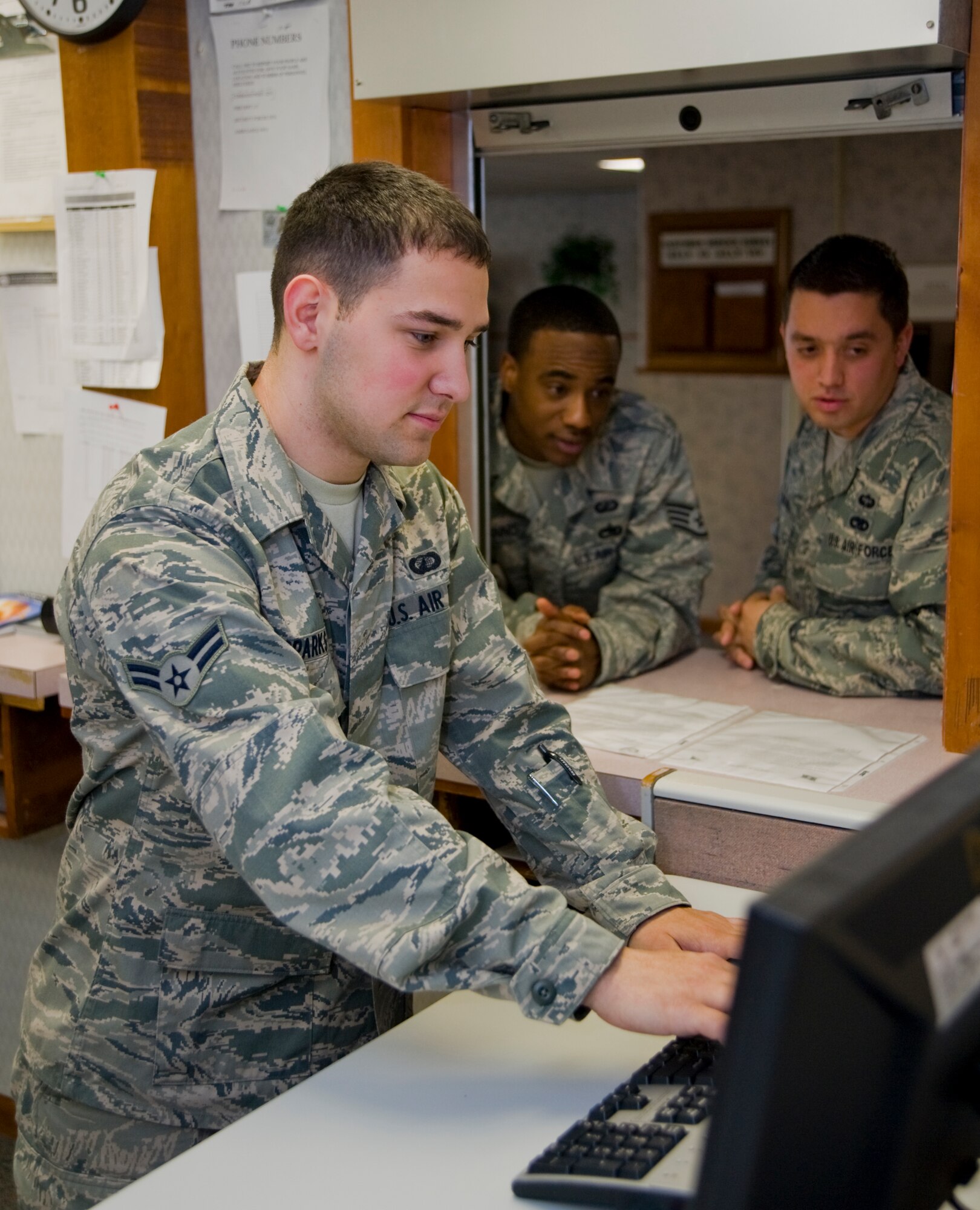Airman 1st Class Francis Sparks, 22nd Comptroller Squadron customer service technician, assists Team McConnell members with their pay entitlements, May 2, 2011, McConnell Air Force Base, Kan. The Buffalo, N.Y., native also helps Airmen with travel vouchers and military pay issues. 