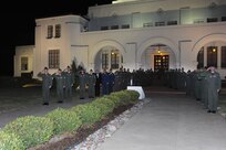 Members from the 12th Flying Training Wing and the 99th Flying Training Squadron line up for a flag lowering ceremony at Randolph Air Force Base?s flagpole at the 12th Flying Training Wing Headquarters Building at 6 a.m. May 3.  The flag was lowered to half staff in remembrance of Maj. Jeff Ausborn who was killed in Kabul, Afghanistan, April 27.  Major Ausborn was a member of the 99th Flying Training Squadron from Randolph and members of his squadron and from throughout the 12 FTW held the ceremony in his honor.  A memorial service takes place May 3 at 10 a.m. at the base theater. At the time of his death, Major Ausborn, a 19-year Air Force veteran, was serving as a C-27 instructor pilot at the 438th Air Expeditionary Wing in Kabul, Afghanistan.(U.S. Air Force photo/Rich McFadden)