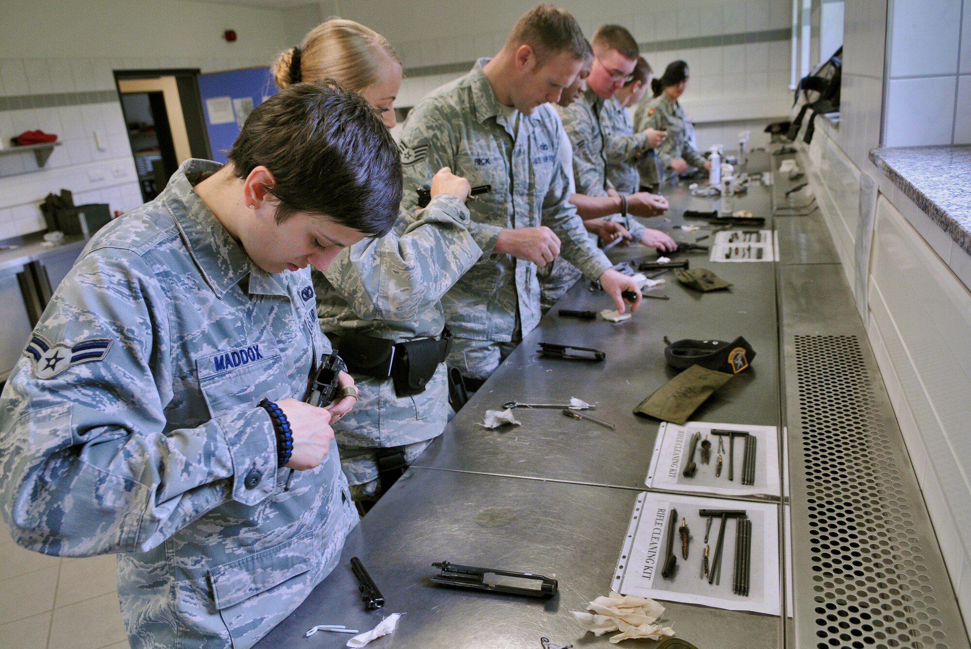 SPANGDAHLEM AIR BASE, Germany – Airmen from the 52nd Security Forces Squadron disassemble and clean their M-9 pistols during weapons qualification training here April 28. Security forces Airmen are required to qualify on their weapons biannually. (U.S. Air Force photo/Senior Airman Nick Wilson)