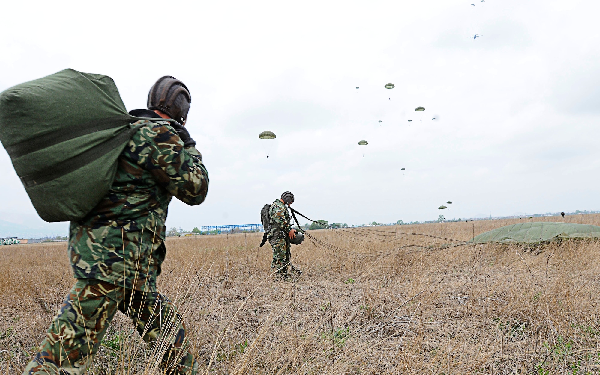Bulgarian Air Force paratroopers land at the drop zone after a successful static line jump from a U.S. Air Force C-130J Super Hercules in support of Thracian Spring 2011, Plovdiv, Bulgaria, April 28, 2011. Thracian Spring 2011 is a two week on-site training designed to build partnerships between the U.S. and Bulgarian Air Force. (U.S. Air Force photo by Airman 1st Class Desiree W. Esposito)