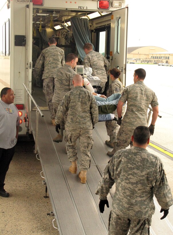 An aeromedical evacuation crew carries Army Spc. Adam Castagna, who