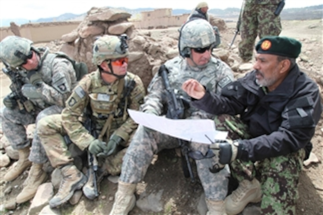 U.S. Army Lt. Col. Darren C. Rickettes (left), Lt. Col. Donn H. Hill (2nd from left) and Deputy Commanding General of Afghan Development Brig. Gen. John Uberti, 101st Airborne Division, talk with an Afghan National Army commander during Operation Overlord in the Naka district of Paktika province, Afghanistan, on April 14, 2011.  Operation Overlord is a division-level air assault mission designed to trap Taliban forces in the province.  