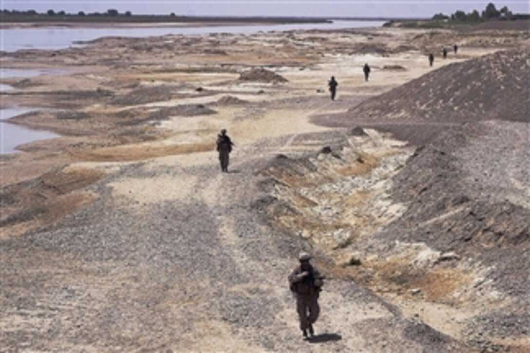 U.S Marines patrol along the Helmand River after visiting a local school in the Garmsir district in Afghanistan's Helmand province on April 26, 2011.  The Marines are assigned to the 1st Battalion, 3rd Marine Regiment.  