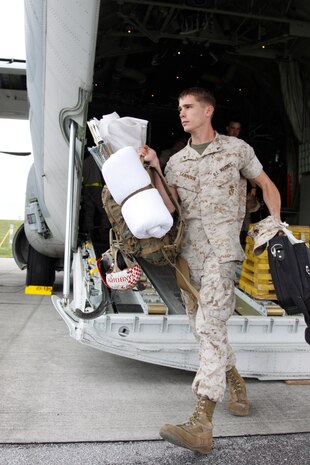 Lance Cpl. William C. Sanborn, a Marine All Weather Fighter Attack Squadron 533 ordnance technician, disembarks from the KC-130 that carried him and his fellow VMFA(AW)-533 Marines to Kadena Air Base May 4. VMFA(AW)-533 made the journey from Marine Corps Air Station Iwakuni to participate in the Marine divisions tactics course, which is slated to start later this month.