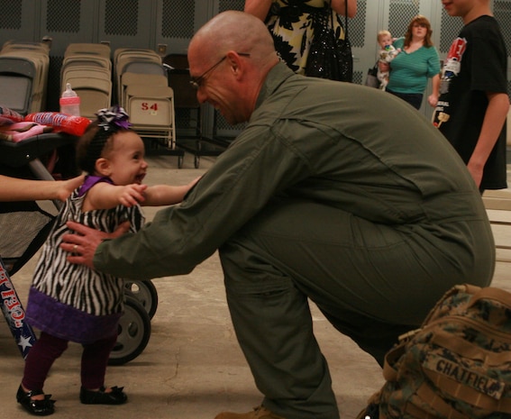 SSgt. Randall W. Chatfield, Initial Response Force A, Chemical Biological Incident Response Force, greats his youngest child after returning home from a month long deployment in support of Operation Tomodachi. The Marines of IRF A Deployed to Japan after a catastrophic earthquake and soon after tsunami shook the country and critically damaging the nuclear power plant Fukushima Dai-ichi. (Photo By Sgt. France L Goch)