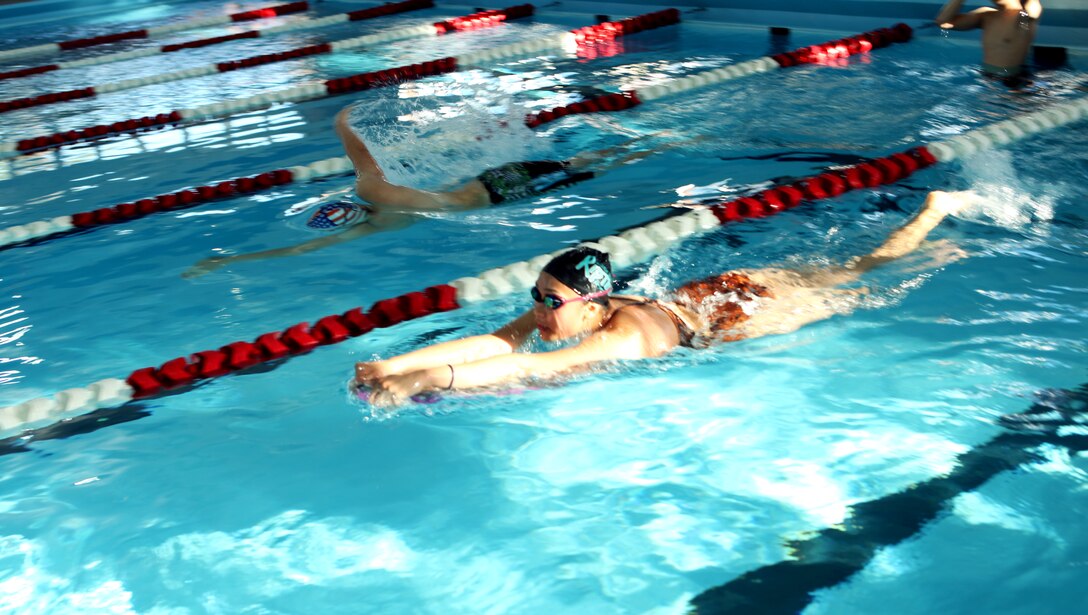 Tyler Ducar (left) and Rhianne Hsu, both swimmers with the Marine Corps Base Camp Lejeune Swim Team “Sharks”, race down a swimming lane during practice at the Area 5 swimming pool aboard the base, May 4.