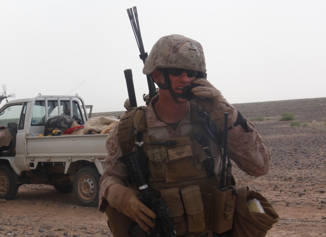 Capt. Michael Scott speaks through a radio during an aerial interdiction operation in southwestern Afghanistan, May 4. Marines from Regimental Combat Team 1, with the aid of 2nd Marine Aircraft Wing assets, conducted a vehicle interdiction and search operation near Afghanistan’s border with Pakistan, May 4. Scott is the air officer for 2nd Air Naval Gunfire Liaison Company , 2nd Brigade, and is deployed out of Marine Corps Base Camp Lejeune, N.C.