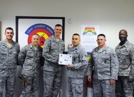 LAUGHLIN AIR FORCE BASE, Texas – Senior Airman Emmanuel Hernandez, 47th Security Forces Squadron, poses with Col. Craig Wills, 47th Operations Group commander, Maj. Ian Dinesen, 47th Security Forces Squadron commander, Chief Master Sgt. Michael King, 47th Mission Support Group superintendent, and fellow members of his squadron after being presented the XLer of the Week award here April 27. The XLer is a weekly award chosen by wing leadership and given to those who consistently make outstanding contributions to Laughlin and their unit. (U.S. Air Force photo by Senior Airman Scott Saldukas)