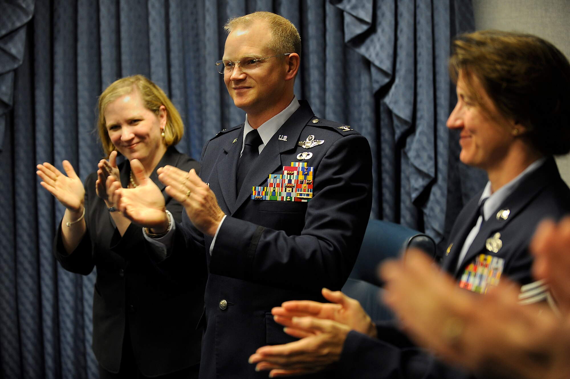 Undersecretary of the Air Force Erin Conaton; Col. Christopher Weggeman, the commander of the 52nd Fighter Wing at Spangdahlem Air Base, Germany; and Chief Master Sgt. Sandra Miller, the 52nd FW command chief, celebrate the wing's recognition as the recipient of the 2011 Commander in Chief's Installation Excellence Award May 3, 2011, during a ceremony in the Pentagon,. (U.S. Air Force photo/Scott Ash)