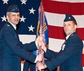 Lt. Col. Marc D'Auteuil, right, accepts command of the 8th Flying Training Squadron from Col. Kurt Meidel, 71st Operations Group commander, during a change of command ceremony May 2 in Hangar 170, at Vance Air Force Base, Okla. Colonel D’Auteuil replaced Navy Cmdr. Scott Wathen, who was assigned to the aircraft carrier, USS John C. Stennis. (U.S. Air Force photo/ Terry Wasson)