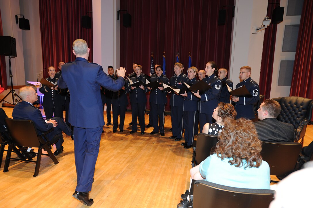 Colonel A. Phillip Waite leads the United States Air Force Singing Sergeants in a musical tribute during his promotion ceremony on April 29 at Historic Hanger 2, Joint Base Anacostia-Bolling, Washington, D.C.  Colonel Waite is the commander and conductor of The United States Air Force Band in Washington, D.C.  (U.S. Air Force photo by Senior Airman Christopher Ruano)